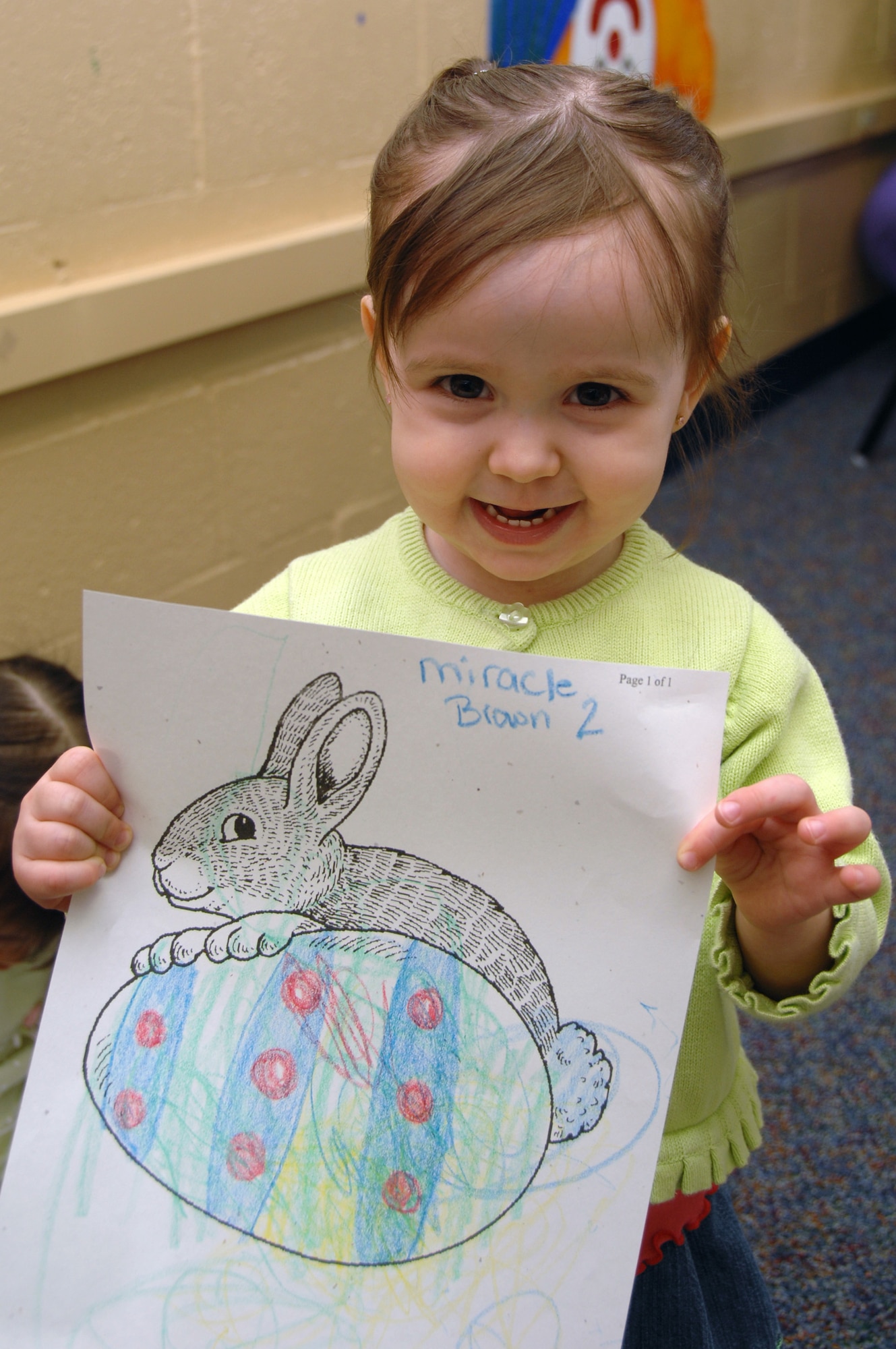 EIELSON AIR FORCE BASE, Alaska -- Miracle Brown, daughter of Renee and Staff Sgt Jeshua Brown, shows off her artwork during the preschool Easter party at the community center here April 5. The event consisted of games, snacks, and an Easter Egg hunt for base children.
(U.S. Air Force Photo by Staff Sgt Joshua Strang)
