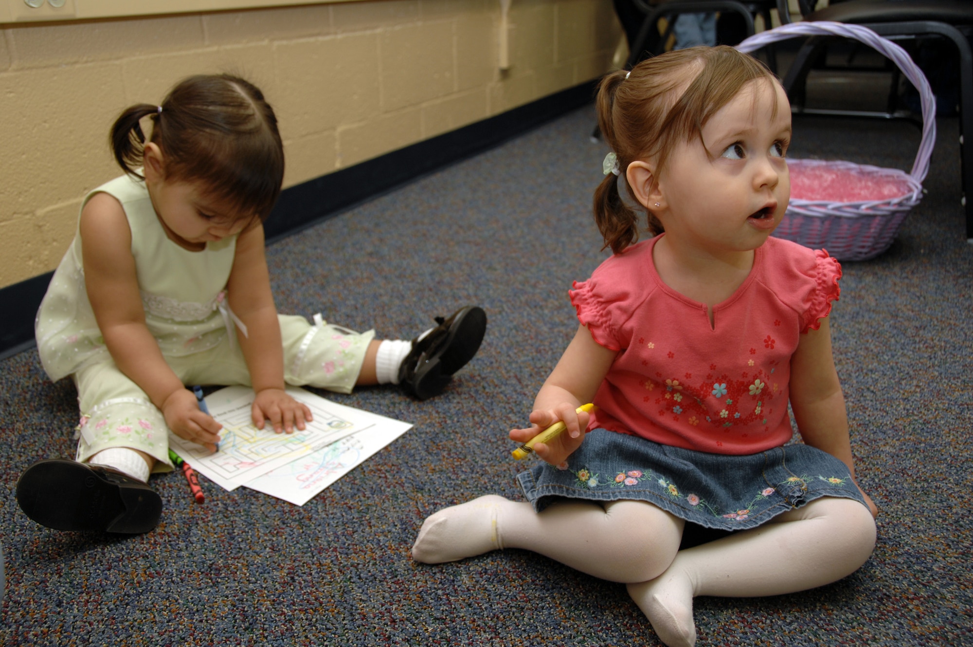 EIELSON AIR FORCE BASE, Alaska --  Adriana Strang (left), daughter of Claudia and Staff Sgt (SSgt) Joshua Strang, colors an Easter picture while Miracle Brown, daughter of Renee and SSgt Jeshua Brown keeps her eye on the Easter Bunny during the preschool Easter party at the community center here April 5. The event consisted of games, snacks, and an Easter Egg hunt for base children.
(U.S. Air Force Photo by Staff Sgt Joshua Strang)