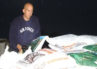 Staff Sgt. Tim Herbert, 324th Training Squadron, loads up on decorative pine bark at the self help center March 30.  About 20 people from his squadron spent some 12 hours on Team Lackland Base Beautification Day creating flower beds in front of their building. (USAF photo by Sid Luna)                                