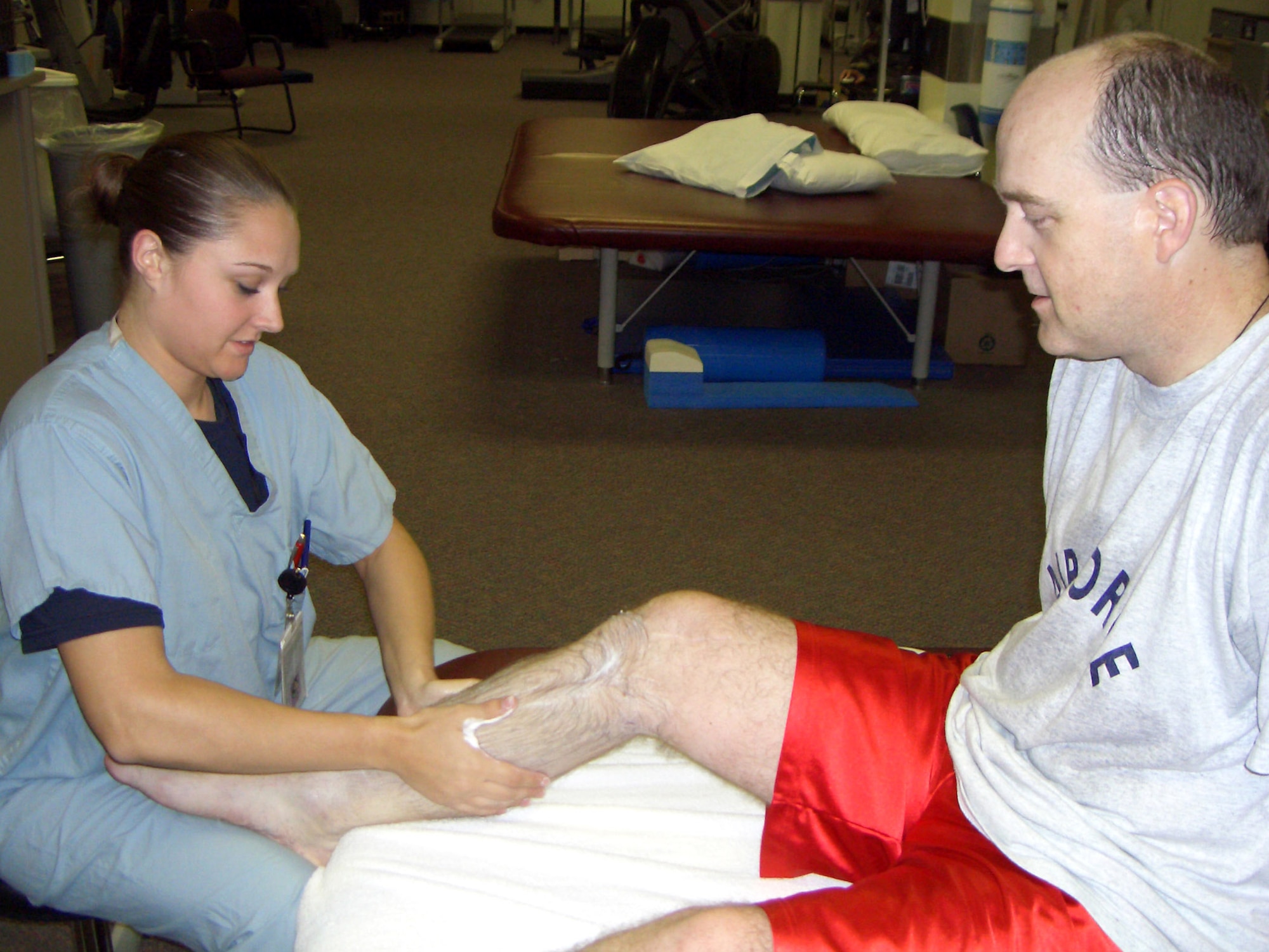 Staff Sgt. Alisa Davis, a physical therapy technician, gives Maj. Matthew Conlan an edema massage to his right leg at Wilford Hall Medical Center, Lackland Air Force Base, Texas, July 6, 2005. Major Conlan received intense physical therapy as part of a nearly two-year recovery program required after surgery for a landmine blast injury received while he was deployed to Bagram Air Base, Afghanistan.  (U.S. Air Force photo/Becky Conlan)
