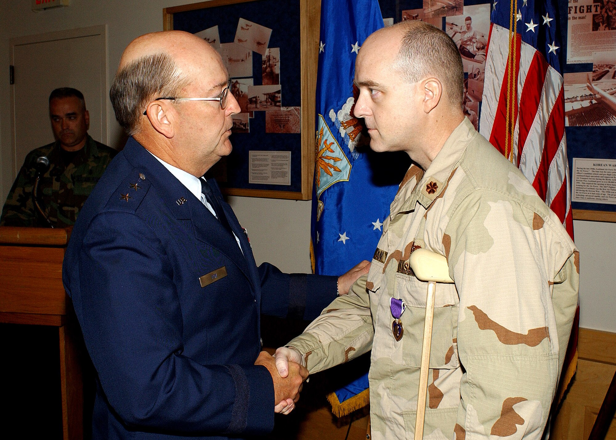 Maj. Gen. Dean Fox, then the Air Force's top civil engineer, presents the Purple Heart to Maj. Matthew Conlan on August 12, 2005, at Wilford Hall Medical Center, Lackland Air Force Base, Texas. The major was awarded the Purple Heart medal for wounds from a blast injury received while serving in Afghanistan. (Courtesy photo) 