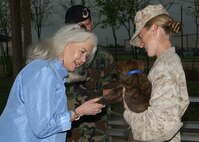 During a tour of Lackland Air Force Base, Texas, on March 29, nationally syndicated columnist Heloise pets Kris, an 8-week-old Dutch Sheppard currently in the puppy program. Heloise was on base for her speaking engagement at the Joint Services Luncheon.  (USAF photo by Alan Boedeker)                                