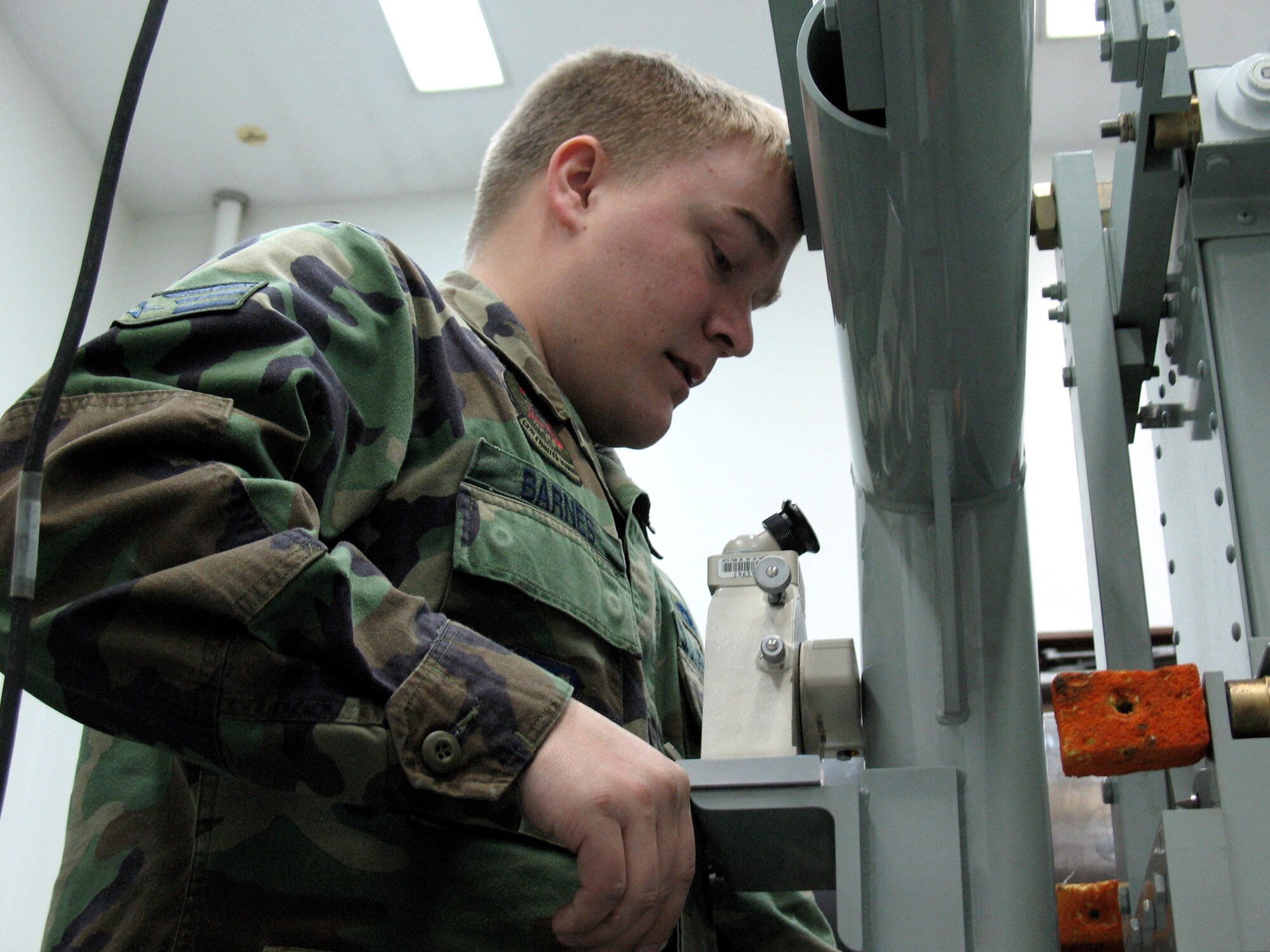 Senior Airman Jason Barnes makes adjustments on the collimeter target scope for an F-16 Fighting Falcon April 5 at Misawa Air Base, Japan. Two seperate knobs control up and down and left and right movements, and moving one will usually throw the other off. It takes coordination and patience to get a perfect alignment. Airman Barnes is assigned to the 13th Fighter Squadron at Misawa AB. (U.S. Air Force photo/Senior Airman Gena Armstrong)
