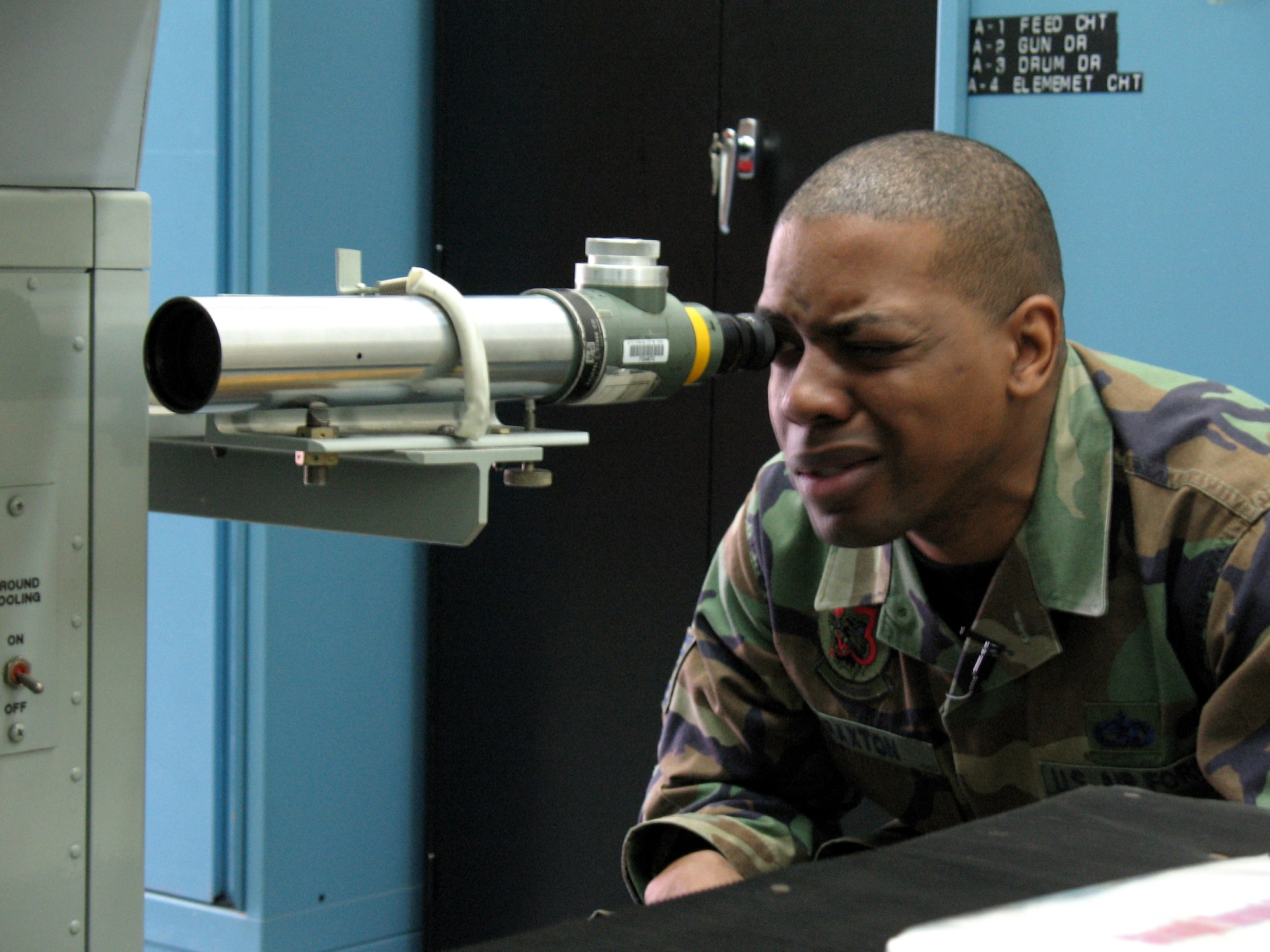 Tech. Sgt. Lawrence Braxton looks through a boresight telescope April 5 at Misawa Air Base, Japan. He watches the crosshairs inside and instructs another Airman where to move the collimeter to get the F-16 Fighting Falcon gun alignment within tolerance levels. Sergeant Braxton is assigned to the 13th Fighter Squadron at Misawa AB. (U.S. Air Force photo/Senior Airman Gena Armstrong)

