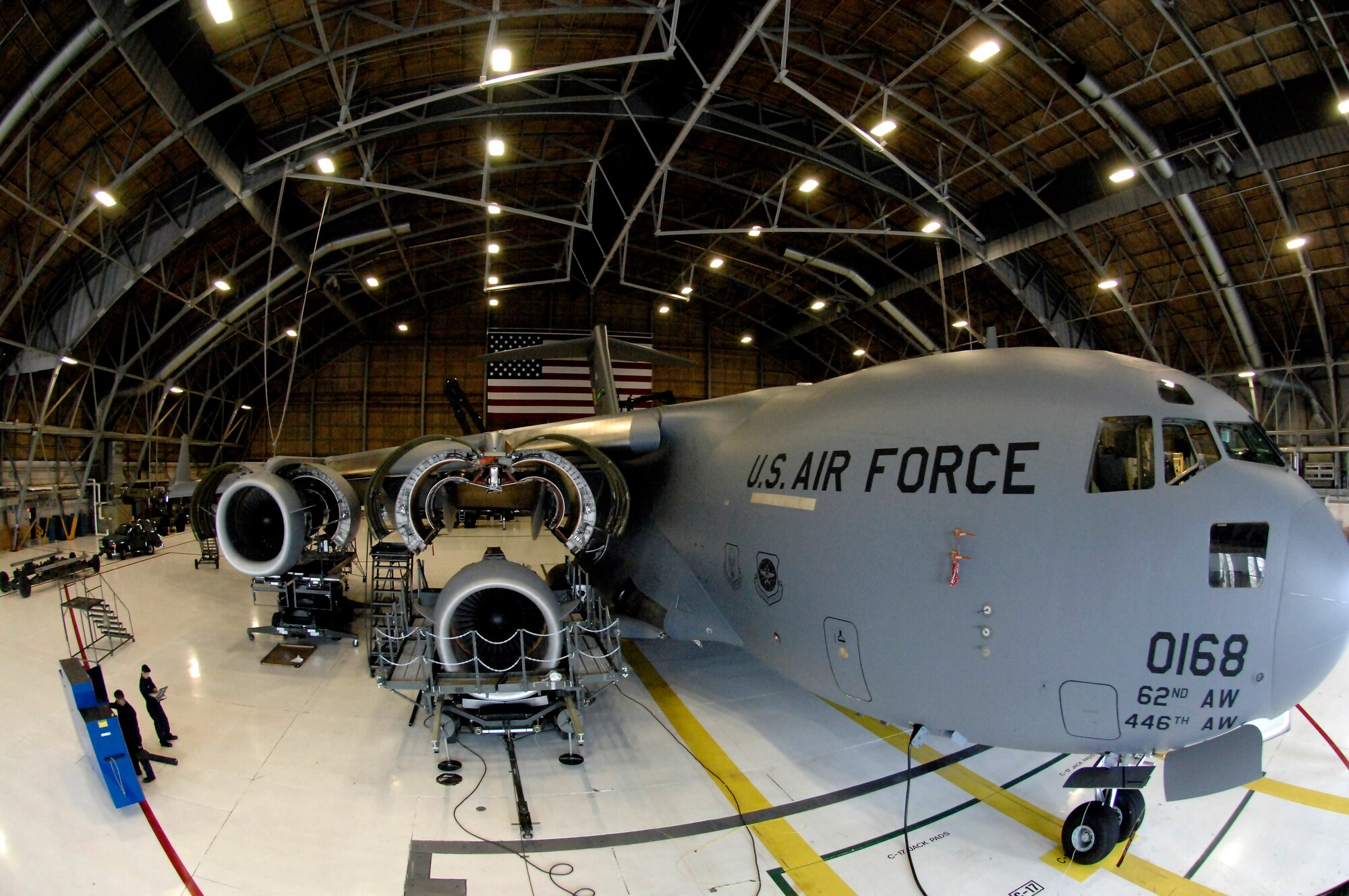 A C-17 Globemaster III sits in a hangar at McChord Air Force Base Wash. as jet engine mechanics assigned to the 62nd Maintenance Squadron prepare to install a repaired engine during a home station inspection on Monday April 2, 2007. (U.S. Air Force photo/Abner Guzman)