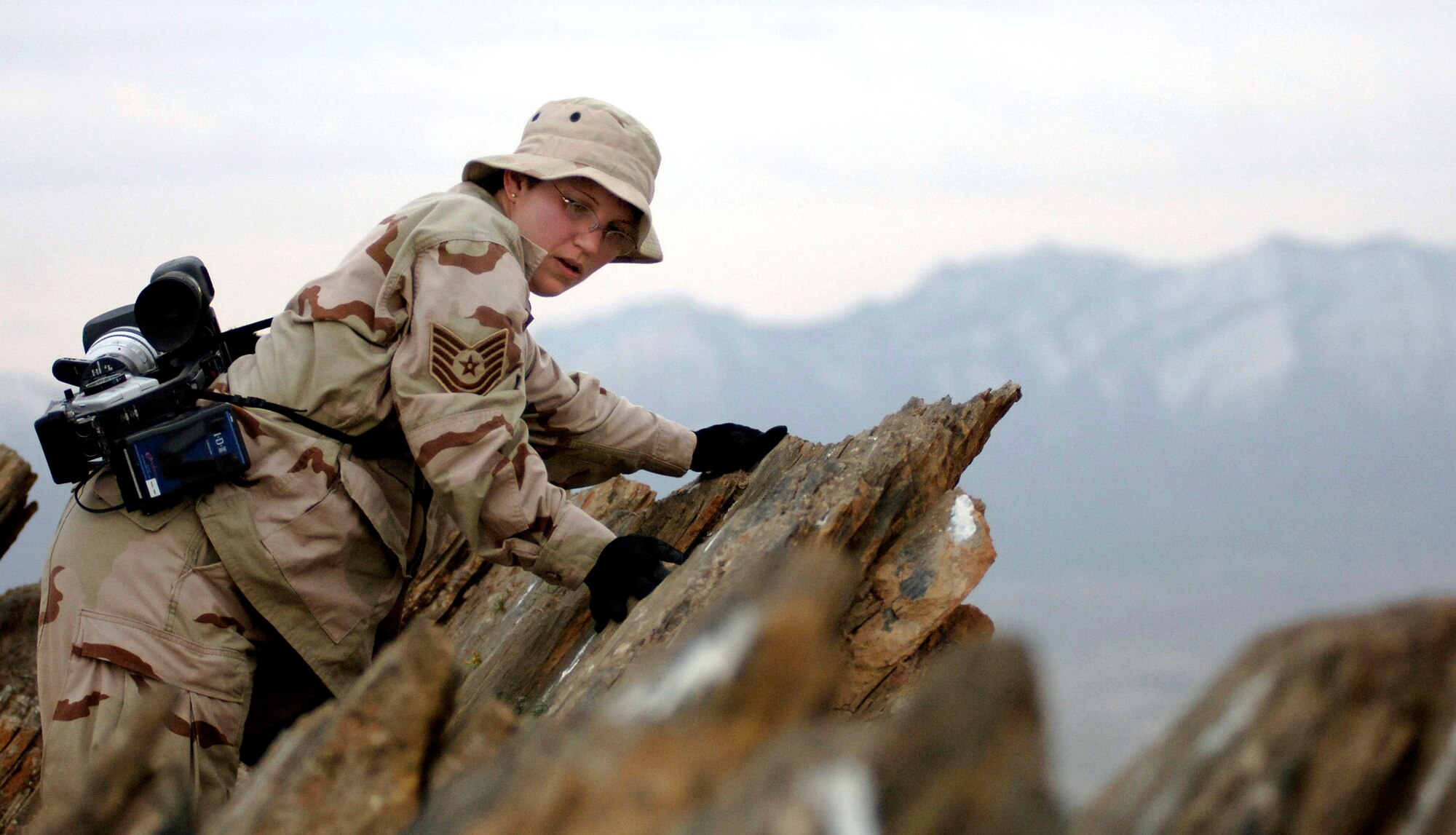 Tech. Sgt. Melanie Adams climbs a mountain March 30 near Kabul, Afghanistan, called the "Ghar."  Making the climb is a long-standing tradition for servicemembers deployed to Kabul.  Sergeant Adams is a news team videographer deployed to Southwest Asia.  (U.S. Air Force photo/Technical Sgt. Cecilio M. Ricardo Jr.)  