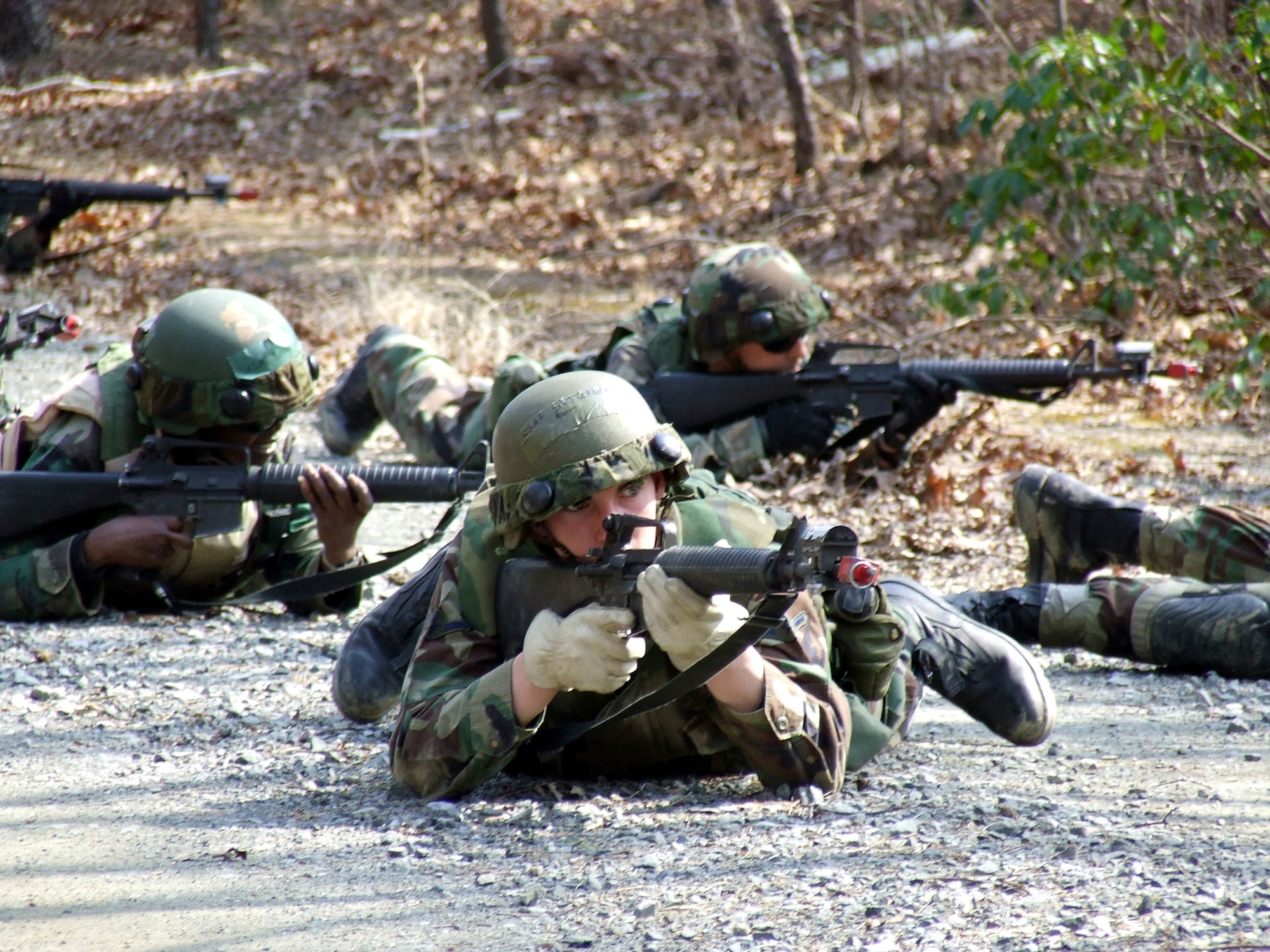 U.S. Air Force Airmen practice squad and fire team maneuvers as part of a tactics and patrolling class for the Advanced Contingency Skills Training Course 07-2B March 14, 2007, on a range at Fort Dix, N.J.  The course, made up of more than 300 Airmen stu dents, prepares Airmen for upcoming deployments through teaching areas such as deployment tactics, patrolling, convoy operations and self defense. (U.S. Air Force photo by Tech. Sgt. Scott T. Sturkol) 