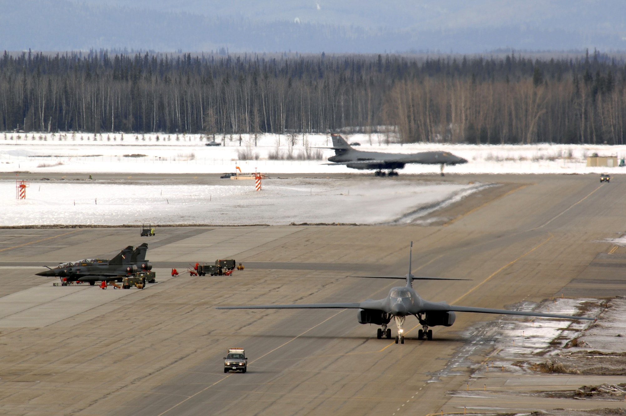 Two B-1B Lancers from Ellsworth Air Force Base, S.D., taxi on the flightline for Red Flag-Alaska 07-1 April 3 at Eielson AFB, Alaska. The series of Pacific Air Forces commander-directed field training exercises for U.S. forces, provide joint offensive counter-air, interdiction, close-air support, and large-force employment training in a simulated combat environment. (U.S. Air Force photo/Staff Sgt. Joshua Strang)
