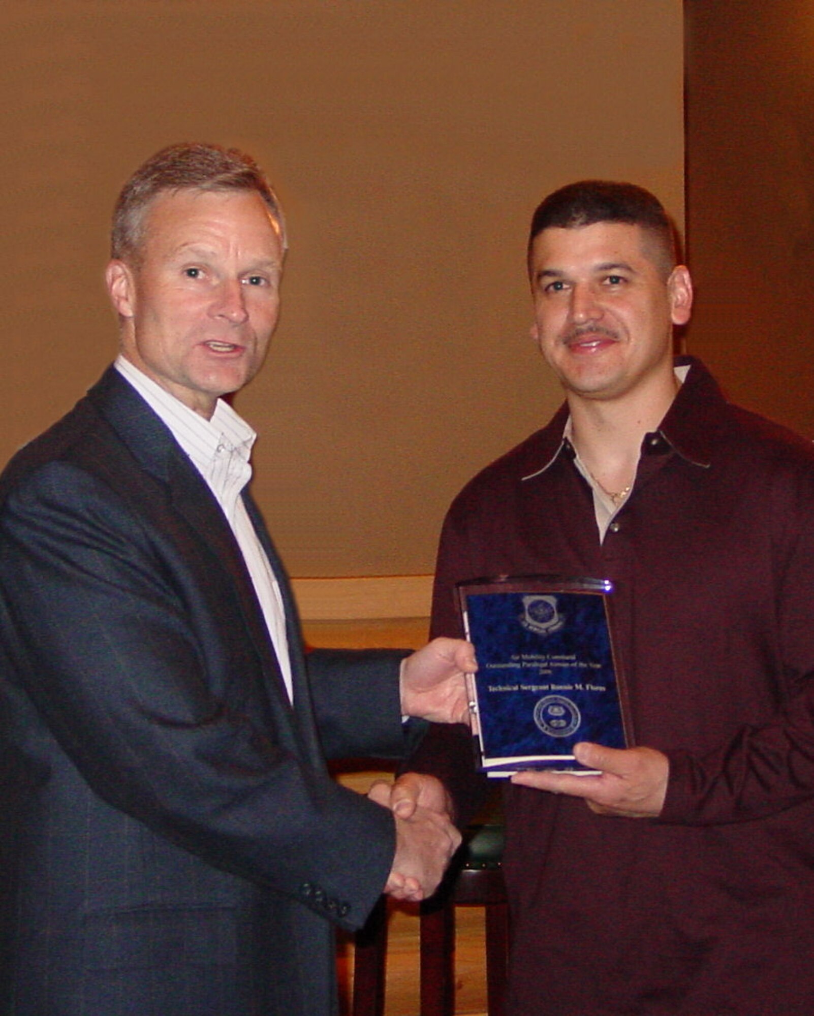 FAIRCHILD AIR FORCE BASE, Wash. -- Brig. Gen. Steven Lepper, Air Mobility Command staff judge advocate, presents the AMC Outstanding Paralegal Airman of The Year award to Tech. Sgt. Ronnie Flores, 92nd Air Refueling Wing civil law NCOIC, March 28. Sergeant Flores coordinated the naturalization of more than 60 Army soldiers recently while attached to the Army 405th Civil Affairs Battalion at Bagram Air Base, Afghanistan. (U.S. Air Force photo/Lt. Col. Christopher Petras)