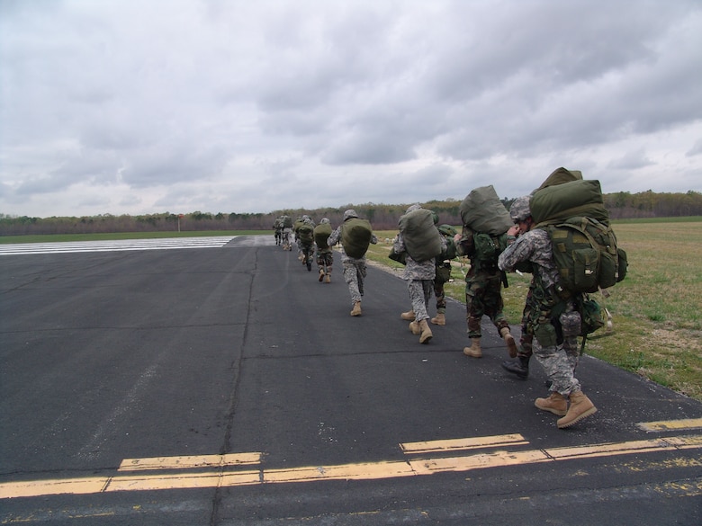 Paratroopers from the 861st Quartermaster Company in Nashville, Tenn., march back to the runway at Arnold Air Force Base's airfield after parchuting during a mock-deployment exercise on base. (Photo by Claude Morse)