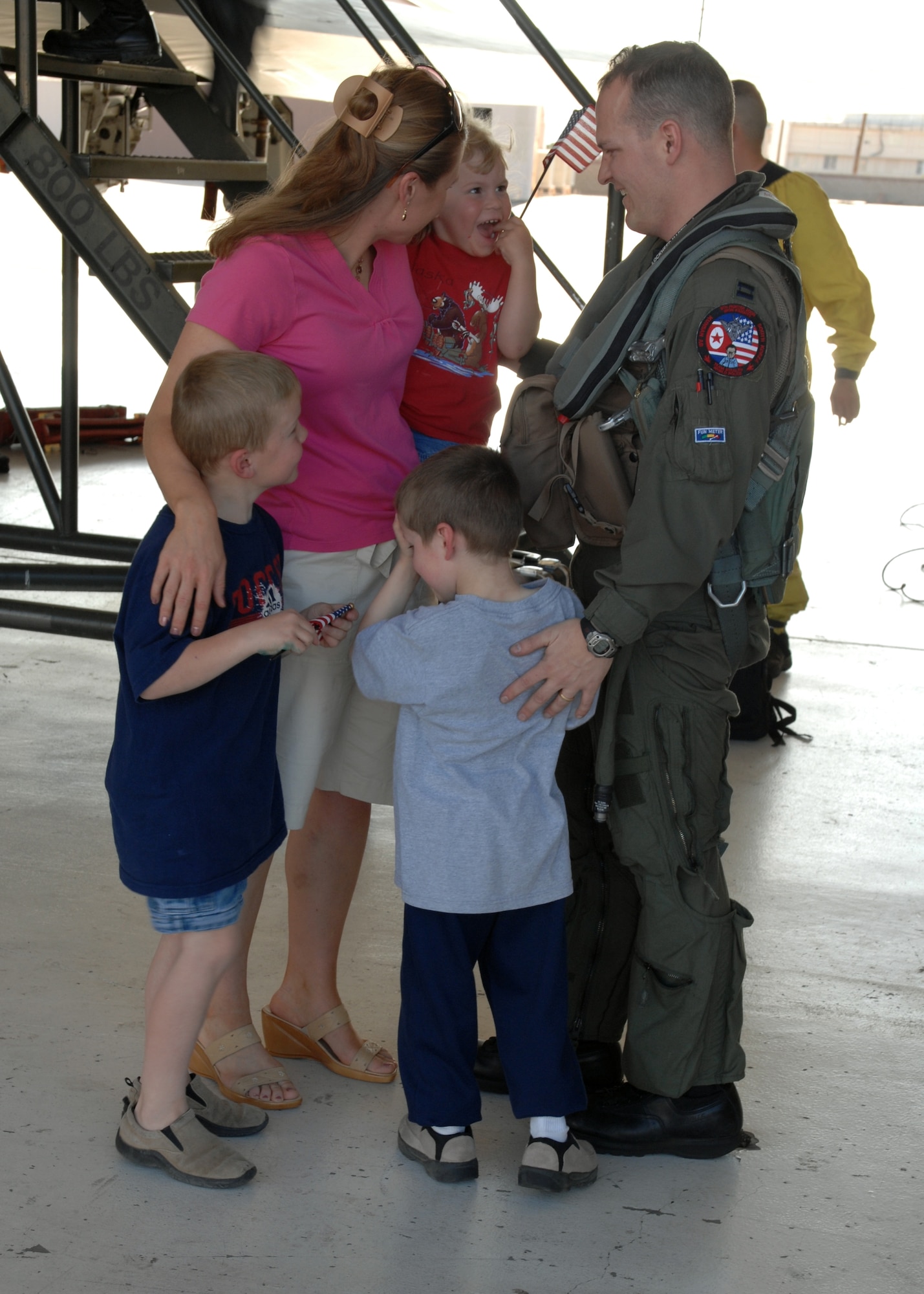 Capt. Tim Smith, 9th Fighter Squadron pilot, is welcomed back by his wife, Katrina, sons, Jackson and Hughston, and daughter, Hannah, after returning home to Holloman from deployment. Captain Smith was part of a deployment that sent more than 300 Holloman Airmen to the Republic of Korea. (U.S. Air Force photo by Airman 1st Class Jamal Sutter)