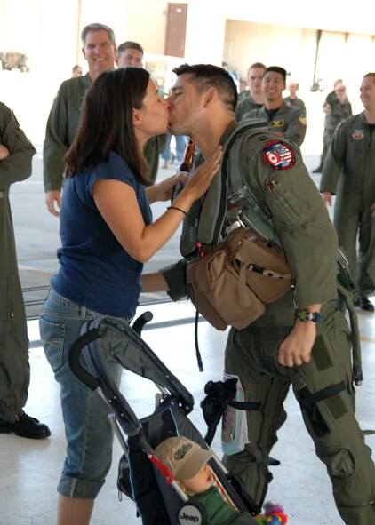 Capt. Michael Driscoll, 9th Fighter Squadron pilot, is welcomed back from deployment by wife, Sonia,  April 4 at Holloman. Captain Driscoll was part of a deployment that sent more than 300 Holloman Airmen to Kunsan Air Base, Republic of Korea. (U.S. Air Force photo by Airman 1st Class Jamal Sutter)