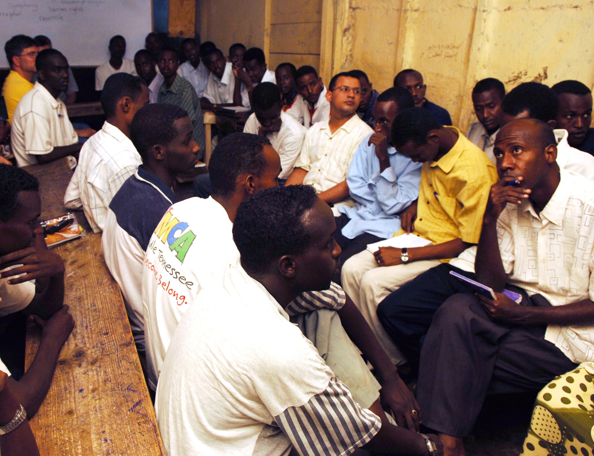 Djiboutians crowd a classroom to participate in an English discussion group session April 5 in Djibouti City, Djibouti. The U.S. Embassy started the program, but rely on support from servicemembers stationed on Camp Lemonier to make the program a success. The English discussion groups are just one of the programs Americans use to foster community relations with their host nation. (U.S. Air Force photo/Daren Reehl)