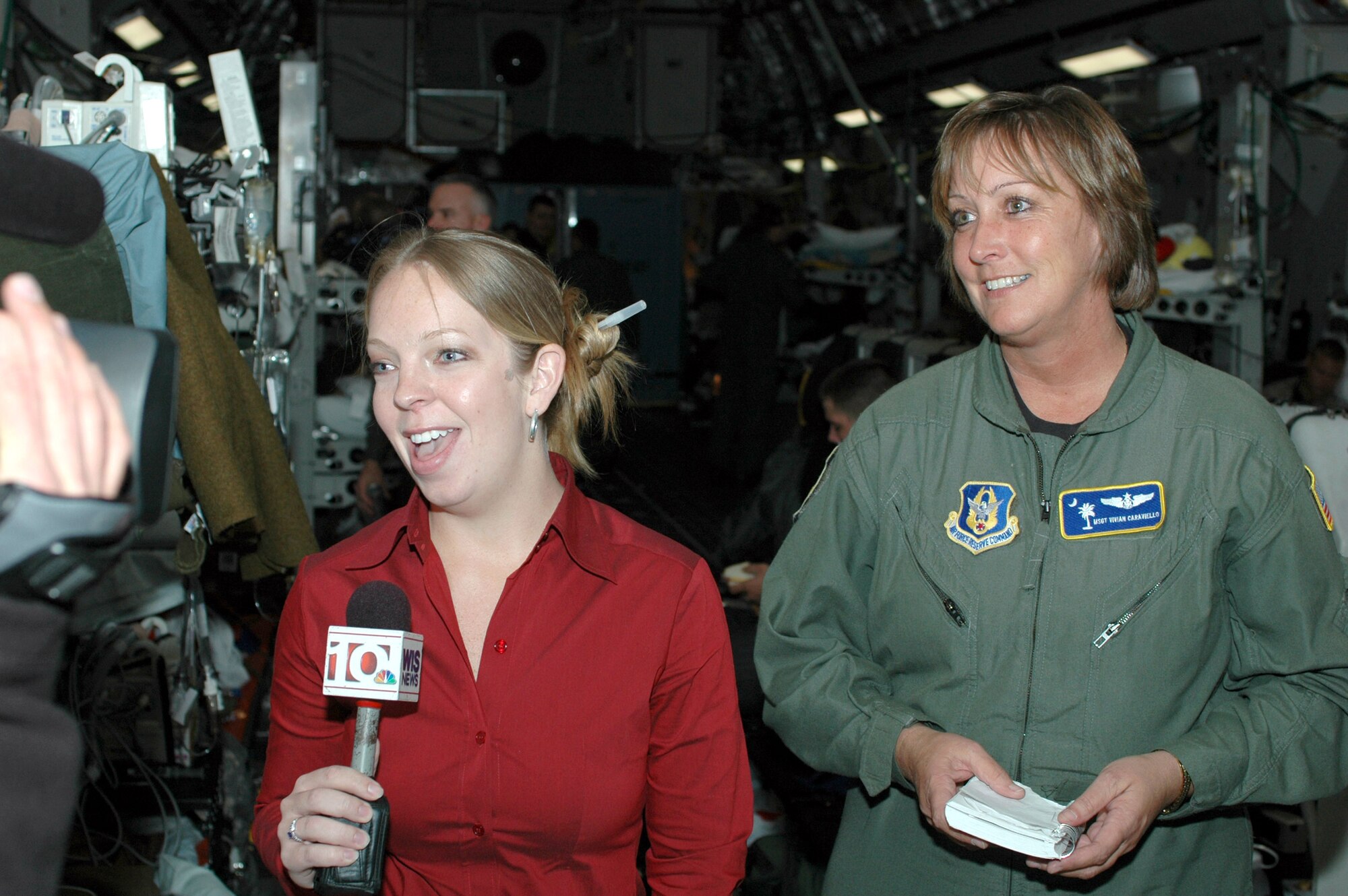 Stefanie Caraviello (left), the senior producer for WIS-TV in Columbia, S.C., interviews her mother, Master Sgt. Vivian Caraviello, a reservist with the 315th Aeromedical Evacuation Squadron at Charleston Air Force Base, S.C. Both Caraviellos were on a recent aeromedical evacuation mission; the mother caring for patients and the daughter telling the story. (U.S. Air Force photo/Capt. Wayne Capps)