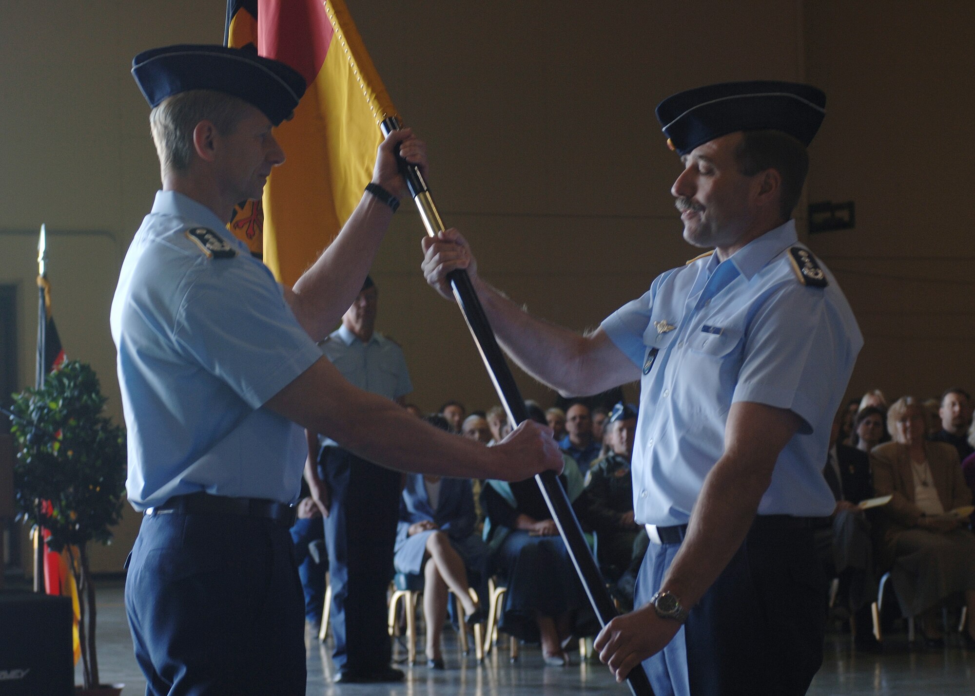 Col. Heinz Joachim Hecht, German air force U.S./Canada commander, passes the guidon to Col. Peter Klement as he assumes command of the GAF.