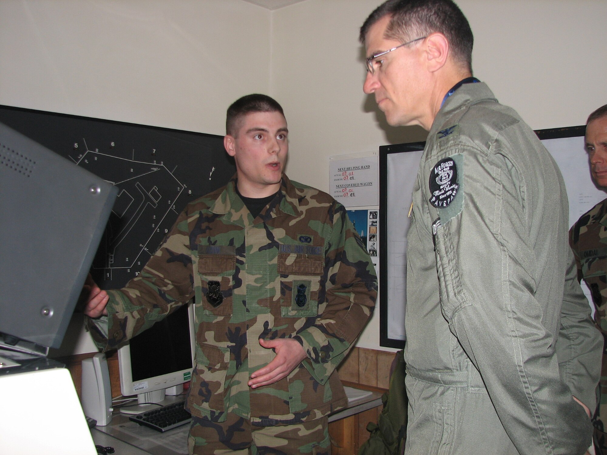 Senior Airman Jonathan Godin, 6th Space Warning Squadron, explains his mission to Col. Jay G. Santee, 21st Space Wing commander, March 16 at Cape Cod, Mass. (U. S. Air Force photo by Staff Sgt. Nadia Barahona)