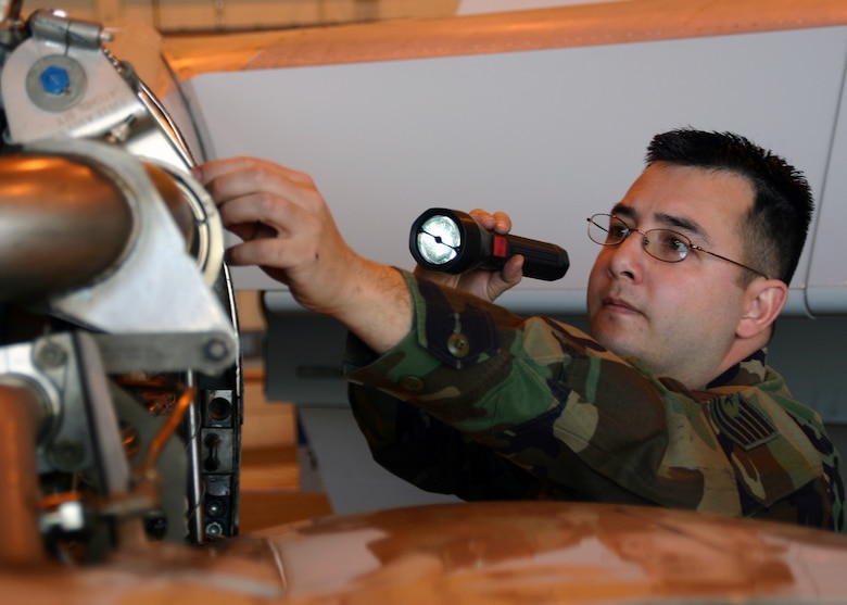 Tech. Sgt. Roy Wiggen, 552nd Maintenance Group Quality Assurance Division, take a look at one of the E-3 Sentry aircraft as it has its annual isochronal inspection.  ISO inspections used to be done every 180 days, but through Air Force Smart Operations for the 21st Century processes the inspections were changed to once a year - saving the Air Force time and money, and allowing theater commanders more use of the E-3.  (Air Force photo by Staff Sgt. Stacy Fowler)