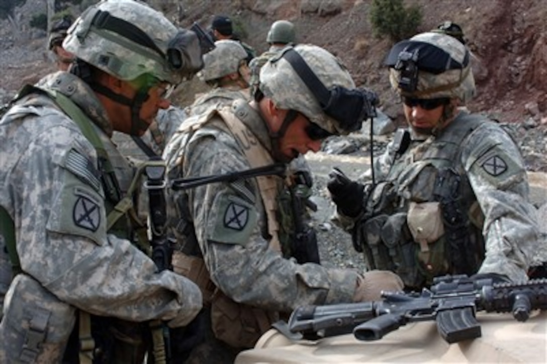 U.S. Army soldiers from the 10th Mountain Division discuss the best way to negotiate rough mountainous terrain during a patrol near the Pakistani border in the Paktika province of Afghanistan on March 30, 2007.  The patrol is part of a mission intended to disrupt enemy movement in areas known to have enemy activity.  The soldiers are assigned to Headquarters and Headquarters Company, 2nd Battalion, 87th Infantry Regiment, 10th Mountain Division.  