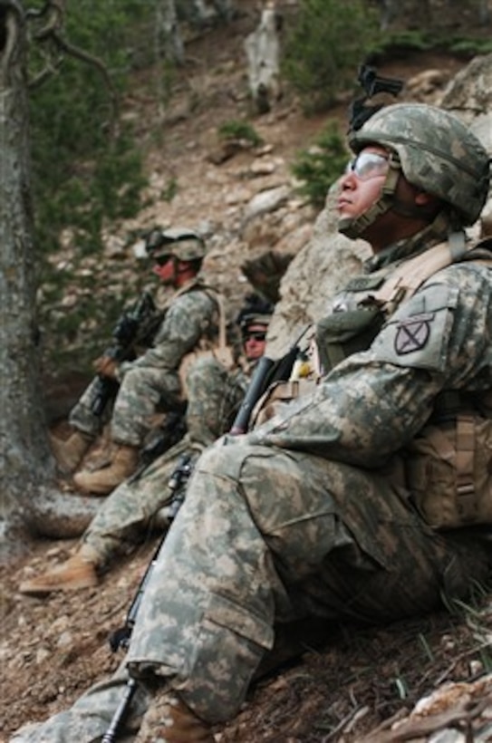 U.S. Army soldiers watch for enemy movement during a patrol in the mountains near the Pakistani border in the Paktika province of Afghanistan on March 30, 2007.  The patrol is part of a mission intended to disrupt enemy movement in areas known to have enemy activity.  The soldiers are assigned to Headquarters and Headquarters Company, 2nd Battalion, 87th Infantry Regiment, 10th Mountain Division.  