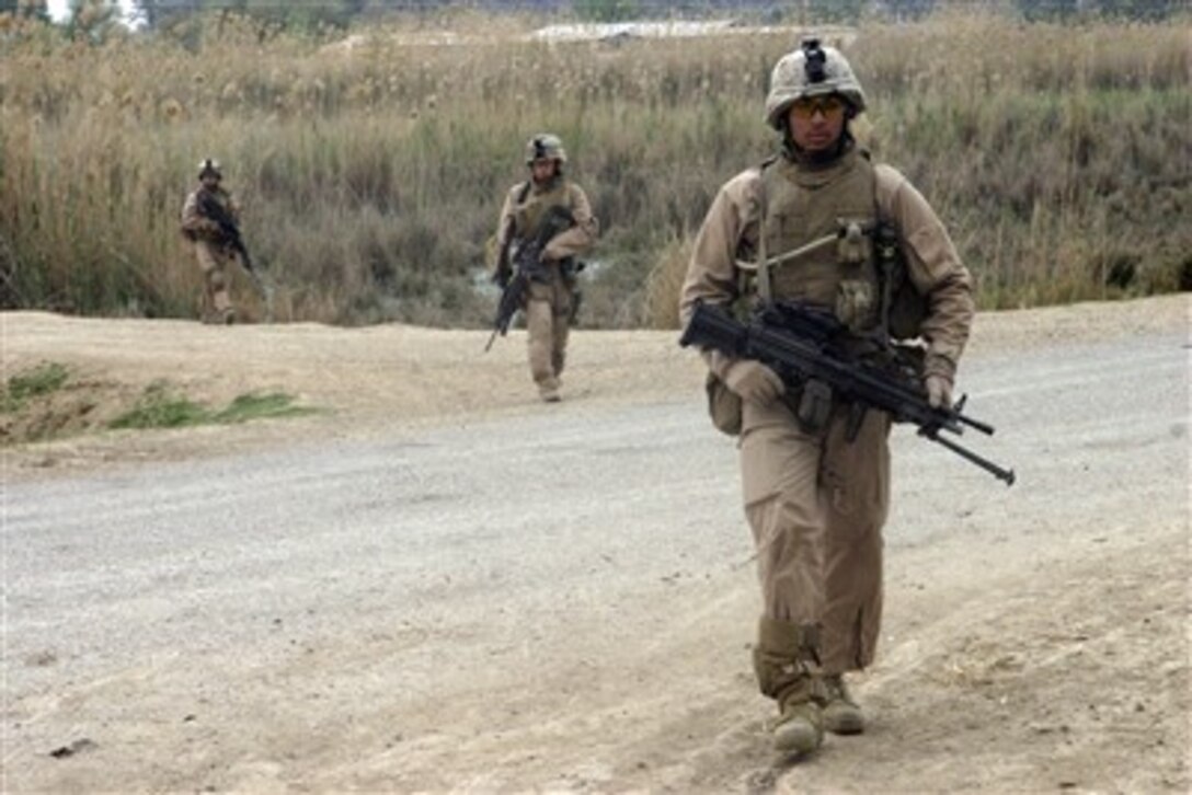 U.S. Marine Corps Lance Cpl. Angel M. Nunez leads his squad across a dirt road as they patrol during an operation in Zaidon, Iraq, on March 24, 2007.  Nunez and his fellow Marines are assigned to Echo Company, 2nd Battalion, 7th Marine Regiment.  