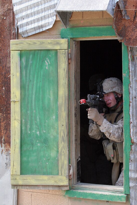 A Marine with Combined Anti-Armor Team, Battalion Landing Team, 3rd Battalion, 8th Marine Regiment, 22nd Marine Expeditionary Unit, posts security out of a window during a raid training evolution aboard Camp Lejeune, N.C., April 6, 2007.  The Marines and sailors of BLT 3/8 are scheduled to deploy as the Ground Combat Element of the 22nd MEU later this year. (U.S. Marine Corps photo by Cpl. Peter R. Miller)