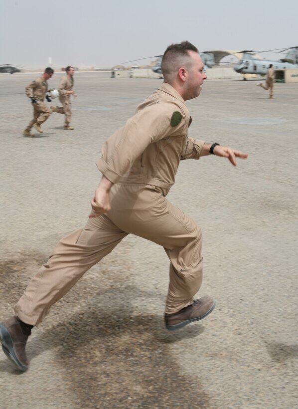 AL TAQADDUM, Iraq- When the "CASEVAC Bell" is rung, corpsmen and flight crew of Marine Medium Helicopter Squadron 161 sprint to their CH-46Es and immediately begin prepping the aircraft for take off, which takes less than 10 minutes.