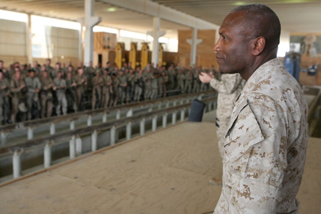 U.S. Marines and Sailors serving with Task Force 3rd Battalion, 4th Marine Regiment, in western Al Anbar Province, Iraq, give a standing ovation to Sgt. Maj. John L. Estrada, sergeant major of the Marine Corps who was at the time 19 days away from ending his honorable service to the Corps.  The Marines and Sailors gave the ovation as a gesture of respect and pride for service under their 15th Sergeant Major of the Marine Corps.  Estrada and Gen. James T. Conway, commandant of the Marine Corps, visited U.S. Marines and Sailors April 6, 2007, to talk about upcoming plans for the Marine Corps, American support for the war in Iraq and to bid them farewell and a job well done.  (Photos by Cpl. Michael S. Cifuentes)