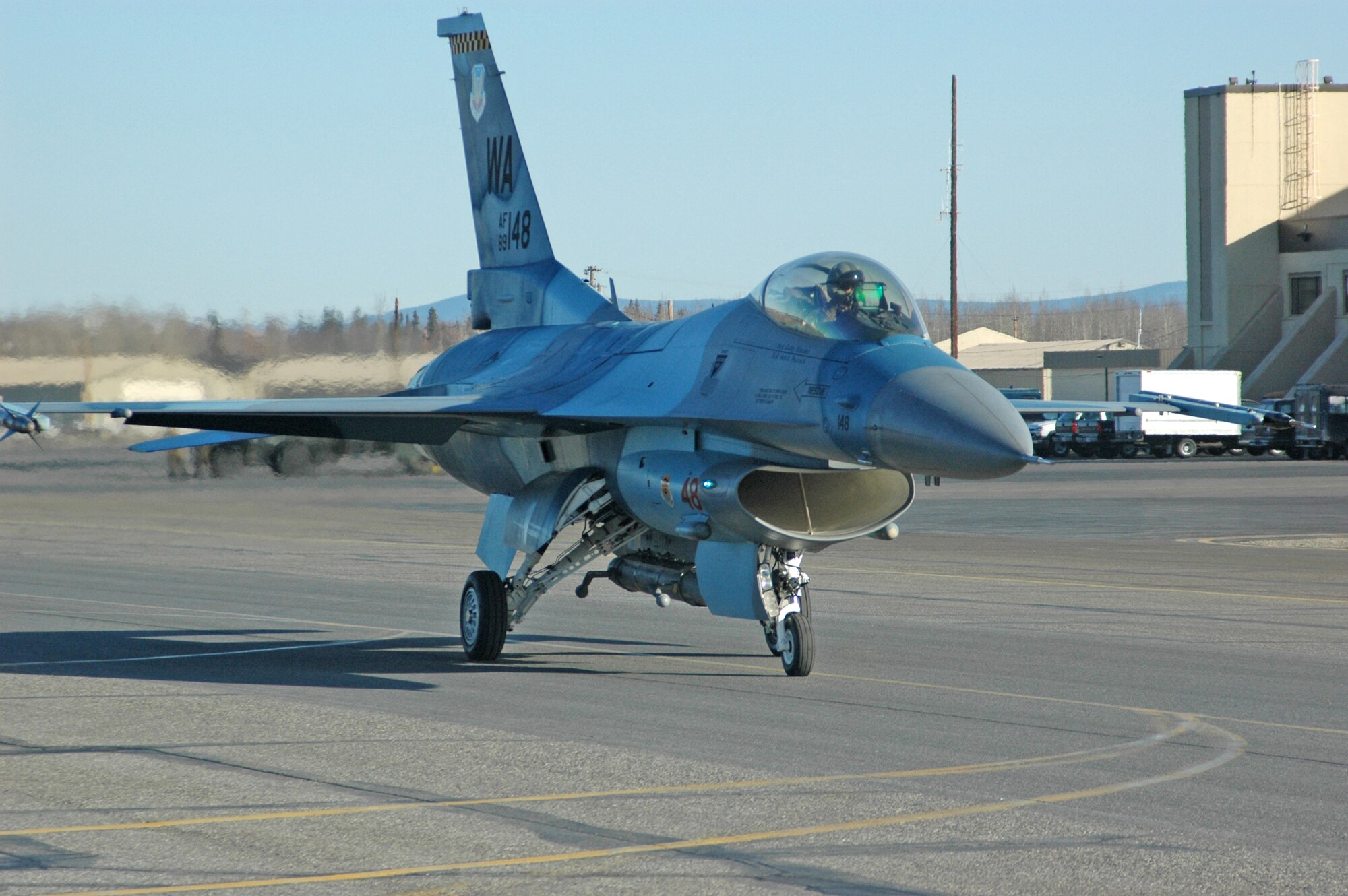 EIELSON AIR FORCE BASE, Alaska -- An F-16 Fighting Falcon from the 64th Aggressor Squadron at Nellis Air Force Base, Nev., taxis down the runway April 6 for a Red Flag-Alaska 07-1 orientation flight. Red Flag-Alaska enables aviation units to sharpen their combat skills by flying ten simulated combat sorties in a realistic threat environment. Additionally, the training allows them to exchange tactics, techniques, and procedures and improve interoperability.  (U.S. Air Force photo by Senior Airman Justin Weaver).