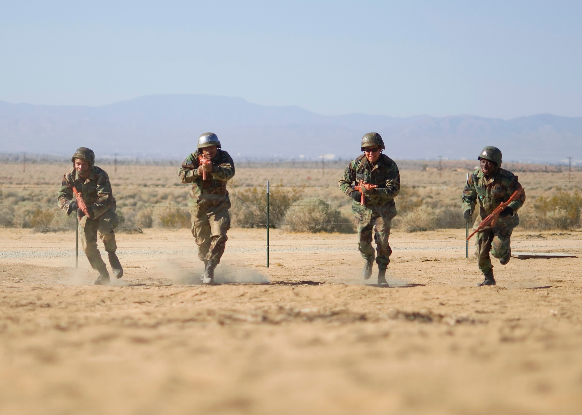 Edwards Airmen run through an obstacle course during the combat skills training March 28 through 29 at Camp Corum here. The training included convoy operations, rifle-fighting techniques, M-16 familiarization and combat tactics. About 80 Airmen participated in the monthly training. (Photo by Mike Cassidy)