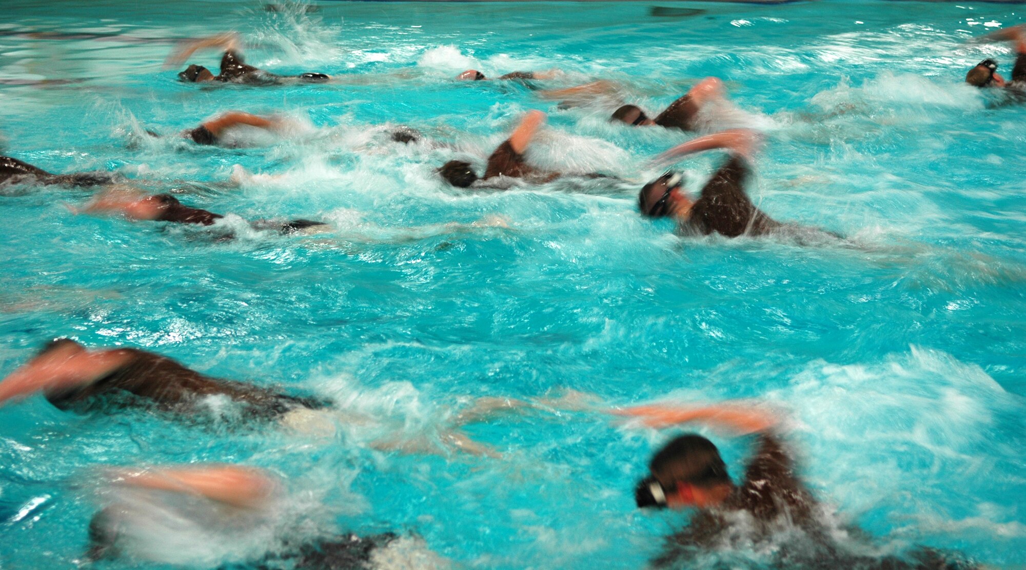Combat rescue officer phase two candidates swim from one side of the pool to the other during training at Fairchild Air Force Base, Wash., March 26.  Trainees undergo an entire week of exercises that will test them both physically and mentally.  Through the week-long course, 43 percent of the students who arrive will be released from the class for various reasons.  (U.S. Air Force photo/Staff Sgt. Larry Carpenter)