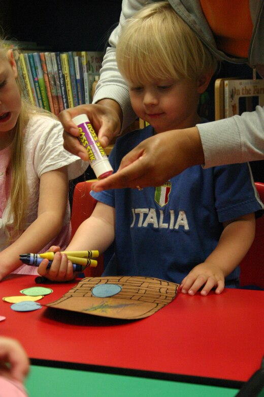 LAUGHLIN AIR FORCE BASE -- Gabe Ludwig, 3 son of Jennifer and 2nd Lt. Steve Ludwig, 86th Flying Training Squadron, recieves help with his Easter crafts after story time at the base library Friday.  (U.S. Air Force photo by Airman Sara Csurilla)