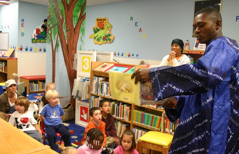 LAUGHLIN AIR FORCE BASE -- Senior Airman Olufemi Owolabi reads the story of the  Easter Bunny to the Base Children, during story time at the base library Friday. During story time the children also listened to an African Folktale "Why The Sun and The Moon Lived In The Sky", also read by Airman Owolabi in his native African attire.  (U.S. Air Force photo by Airman Sara Csurilla)