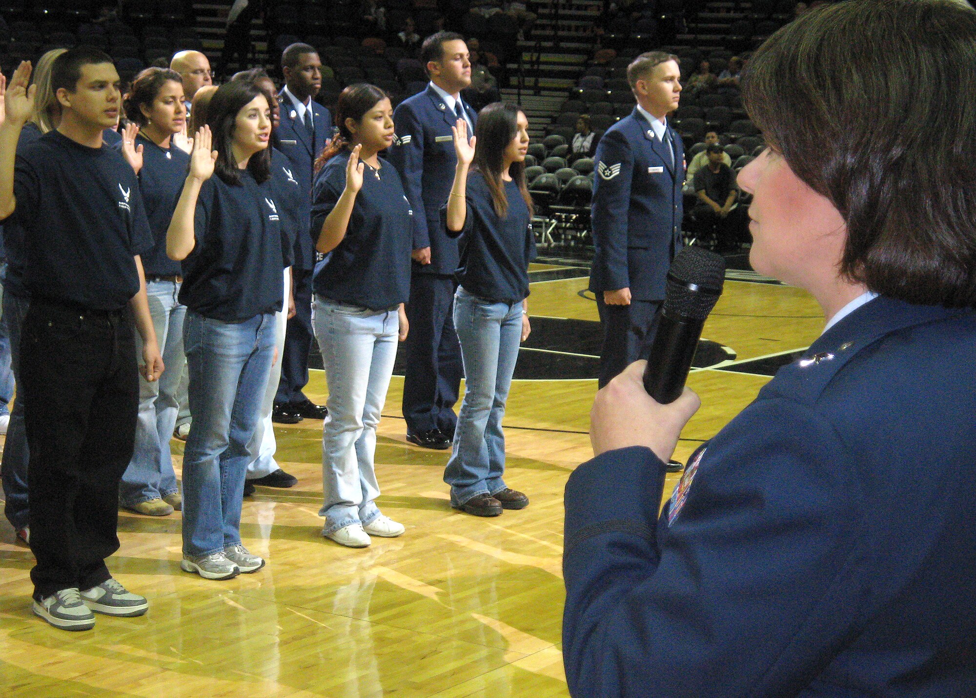 Sixty Air Force Delayed Entry Program members say the oath of enlistment before the San Antonio Spurs and the Phoenix Suns played at the AT&T Center in San Antonio Thursday night. Brig. Gen. Suzanne Vautrinot, Air Force Recruiting Service commander, administered the oath and presented the game ball to Derrick Stafford, the head referee, prior to tip off. (U.S. Air Force photo by Tech. Sgt. Louis Becerra)