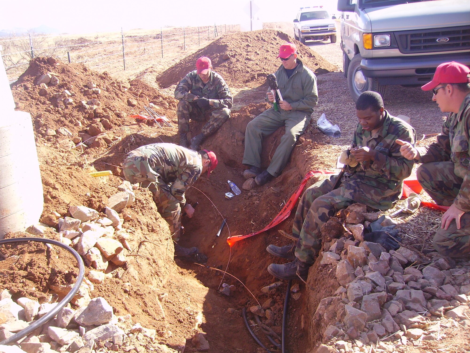 Electricians from the 819th RED HORSE Squadron work to locate primary cables that were placed during prior missions in the area.