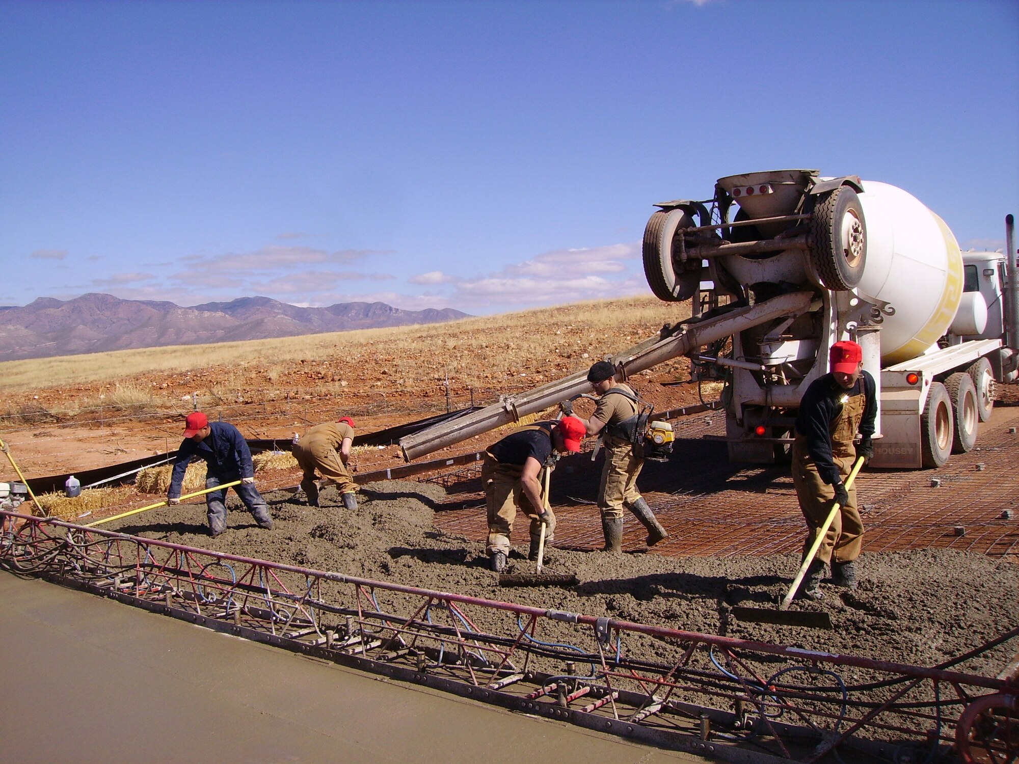 Thirty-six 819th RED HORSE Squadron personnel, including four cooks, deployed to Naco, Ariz., Jan. 27 through March 9 to help repair a stretch of roadway there that was severely affected by water damage in low-lying areas of it. Here, a crew levels cement. 