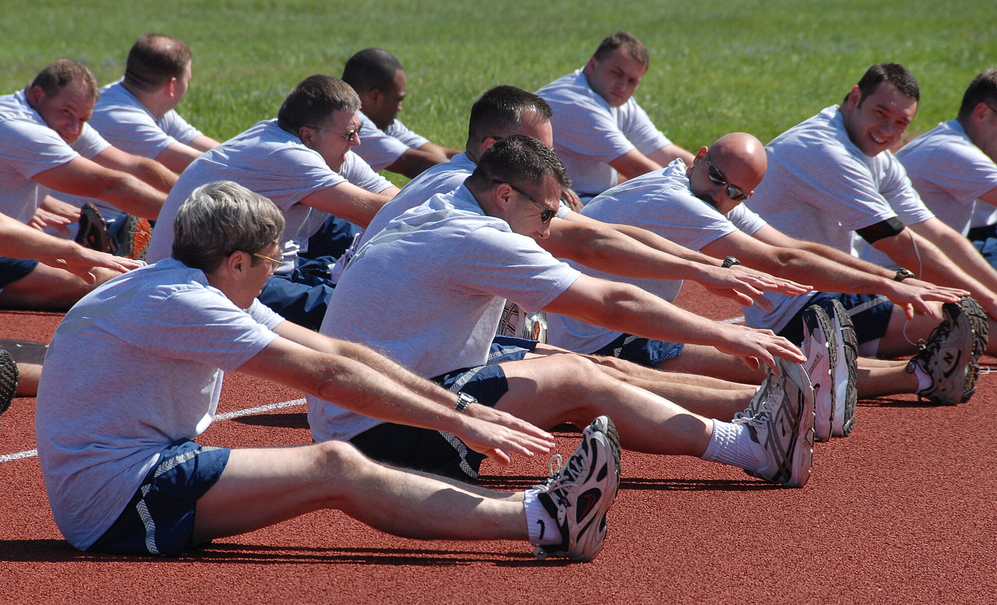 Sheppard personnel stetch out April 4 before hitting the track for the 82nd Training Wing run. Participants completed the requirements for running, sit ups and push ups at the 1-mile track. (U.S. Air Force photo/Mike Litteken)