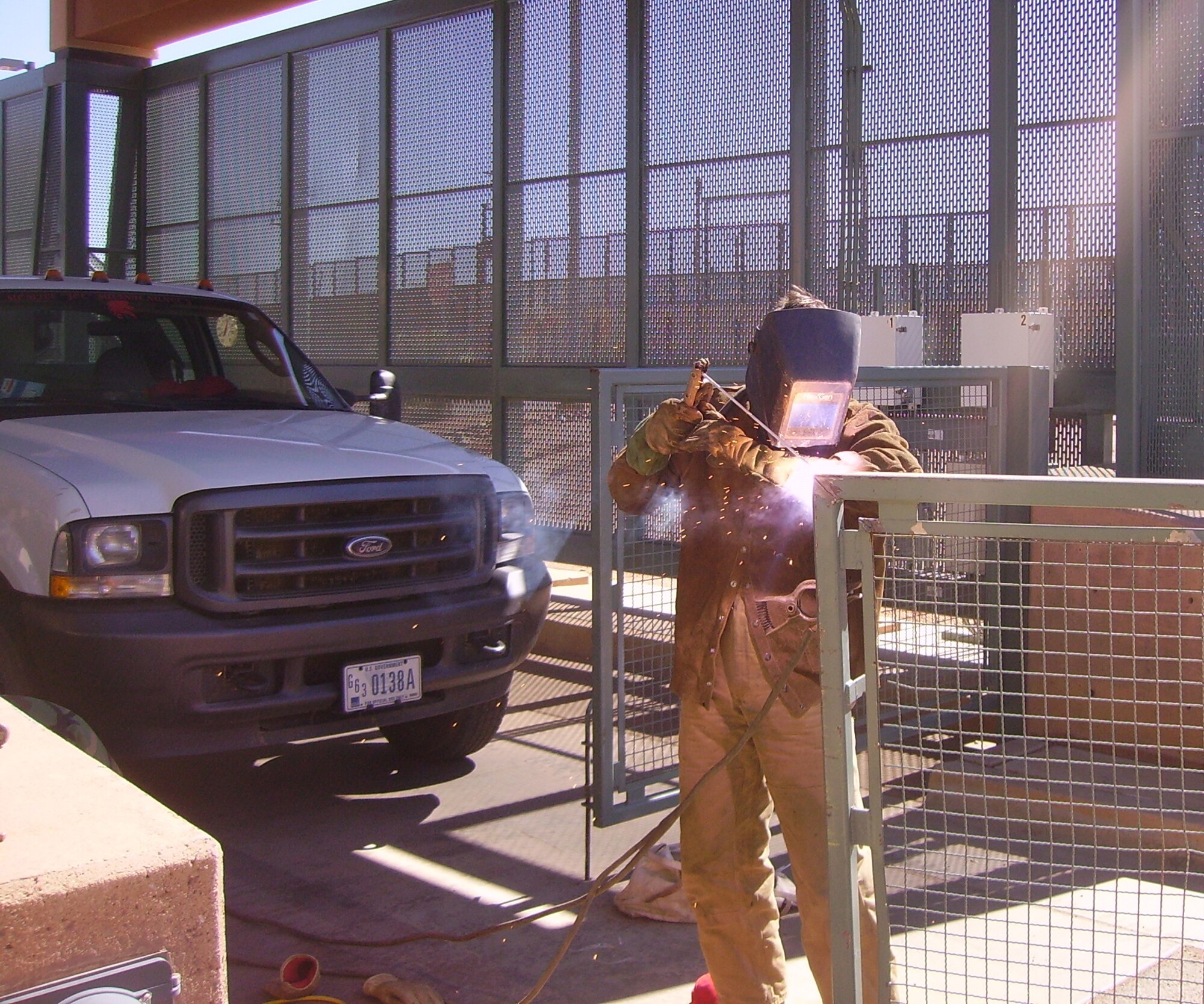 Senior Airman Joshua Jankowski uses a torch welder to repair a gate at the Naco Point of Entry .  