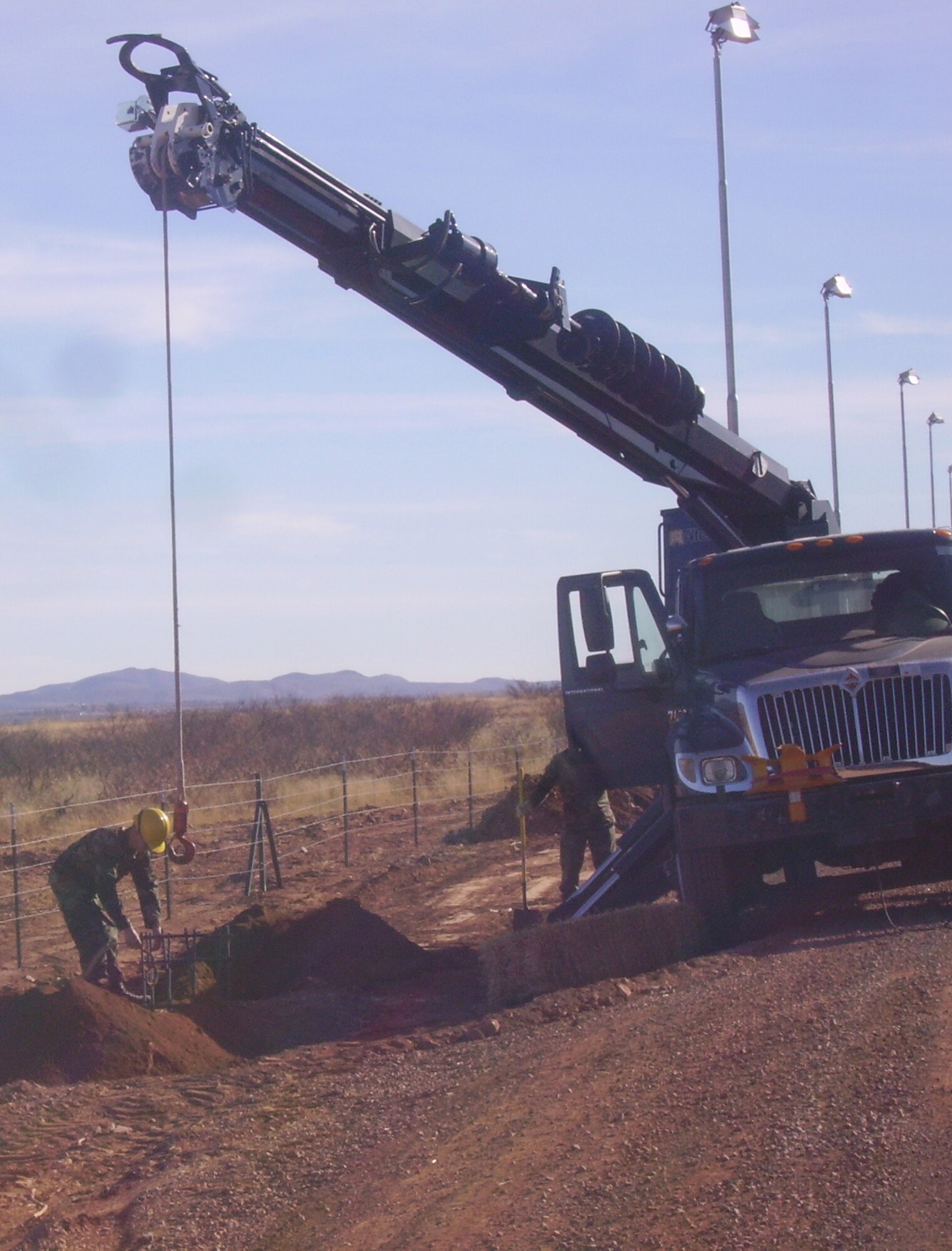 Electricians place rebar cages before installing light poles for the remaing stretch of roadwork the 819th RED HORSE Squadron repaired in Naco, Ariz. 