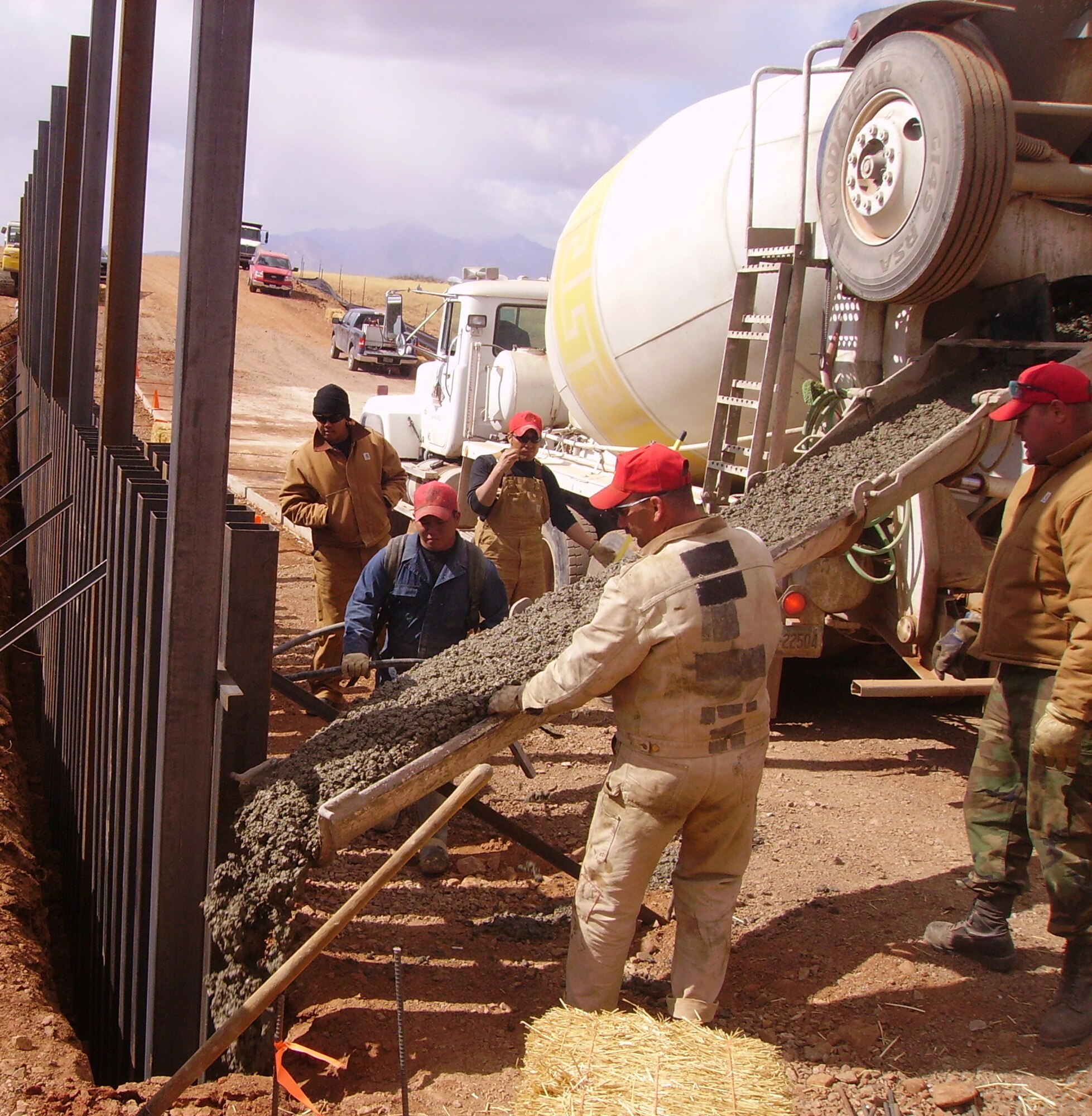 Crews secure the bollard vehicle barriers at a low water crossing site.