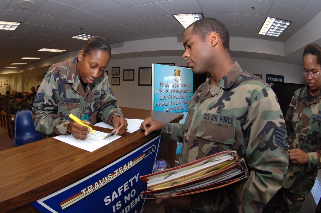 SSgt Candie Simmons, 60th Mission Support Squadron, checks Staff Sgt. Roheem Moore, 60th Medical Surgical Operations Squadron, into the Personnel Deployment Facility during the Crisis Look 07-02 deployment exercise held on Travis Air Force Base, Calif. (U. S. Air Force photo by Nan Wylie)