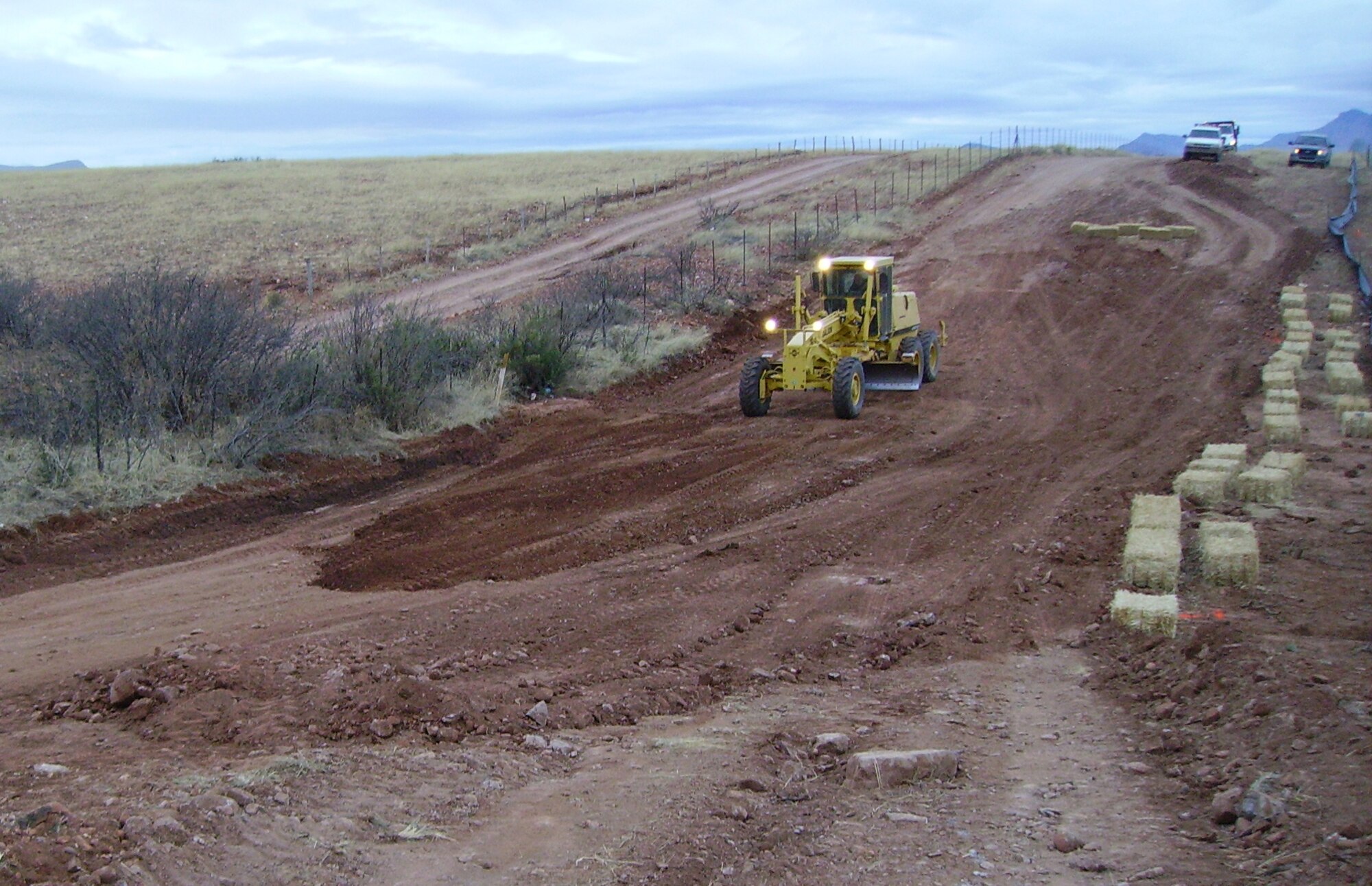 In the first few days after their arrival in Naco, Ariz., crews performed subgrading preparation to the very eroded roadway before getting it ready to install four low water crossings which will eliminate further erosion.