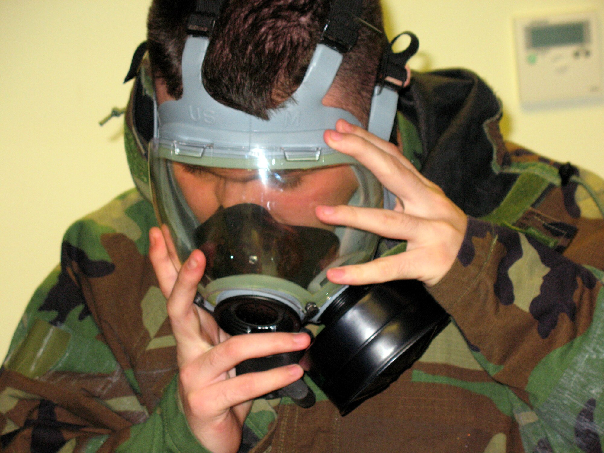 An Airman dons a gas mask during an April 2 exercise at Incirlik Air Base, Turkey. Base members were evaluated on how they could respond to a major earthquake and other scenarios during the exercise to ensure they are prepared and trained for potential threats. (U.S. Air Force photo)
