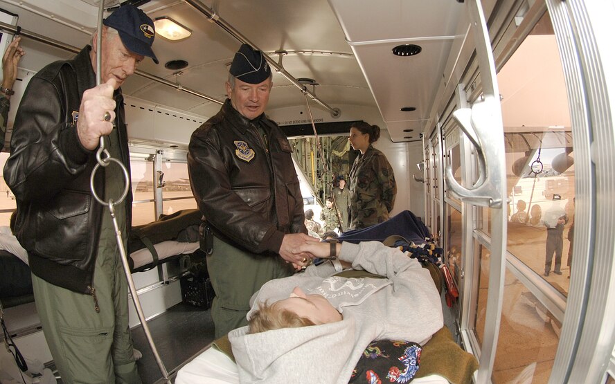 Gen. Duncan McNabb, Air Mobility Command commander, and Herb Kelleher, a founder and Executive Officer for Southwest Airlines, visit with wounded servicemembers who arrived at Andrews Air Force Base, Md. April 4 after an Aeromedical evacuation flight from Ramstein, Germany. Mr. Kelleher, who was chosen as the AMC Honorary Commander, visited three AMC bases with General McNabb to receive an orientation to the command and visit with Airmen.