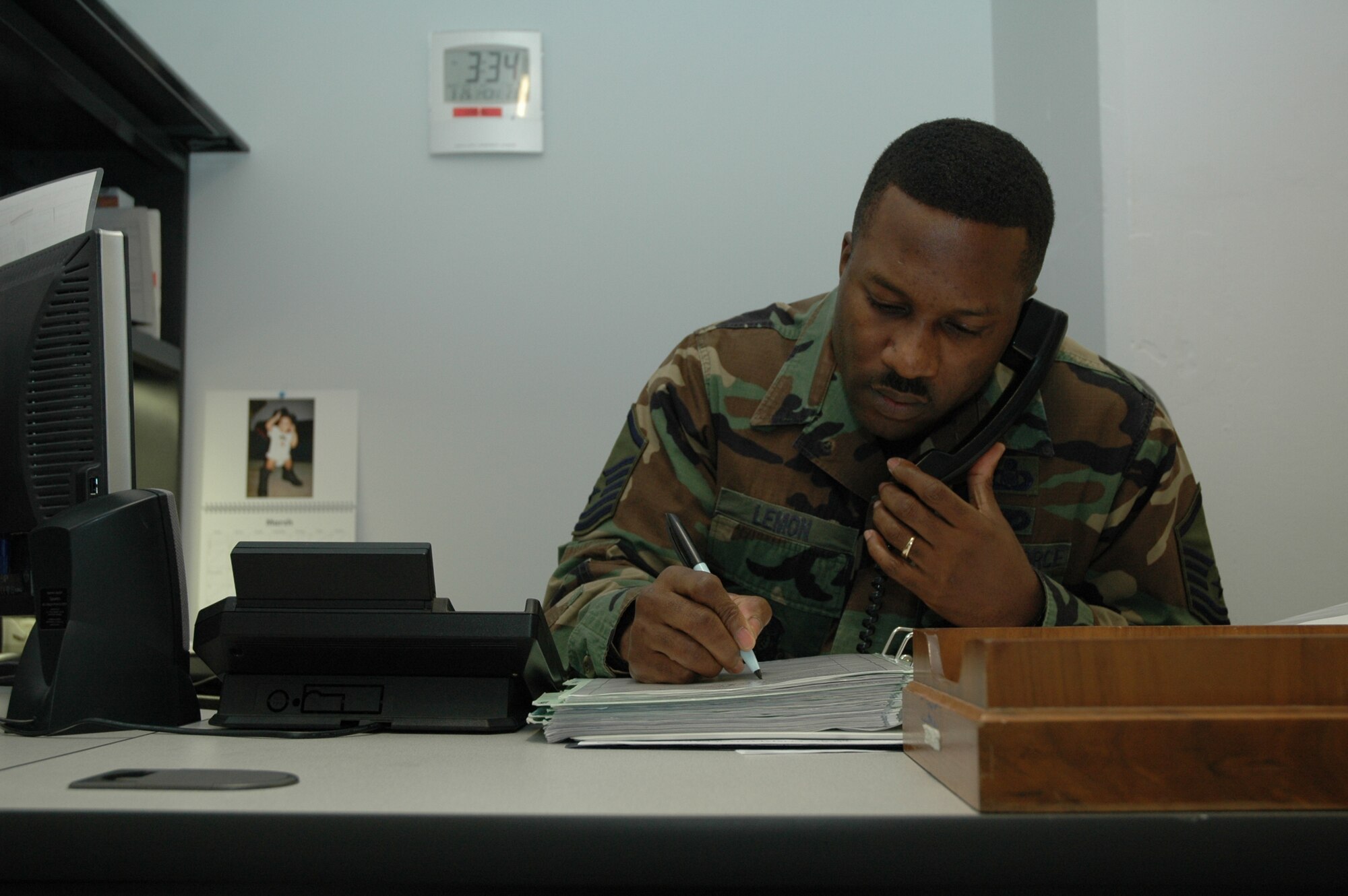 Master Sgt. Derek Lemon, 341st Space Wing Command Post Superintended takes down information from a dispatch call. 