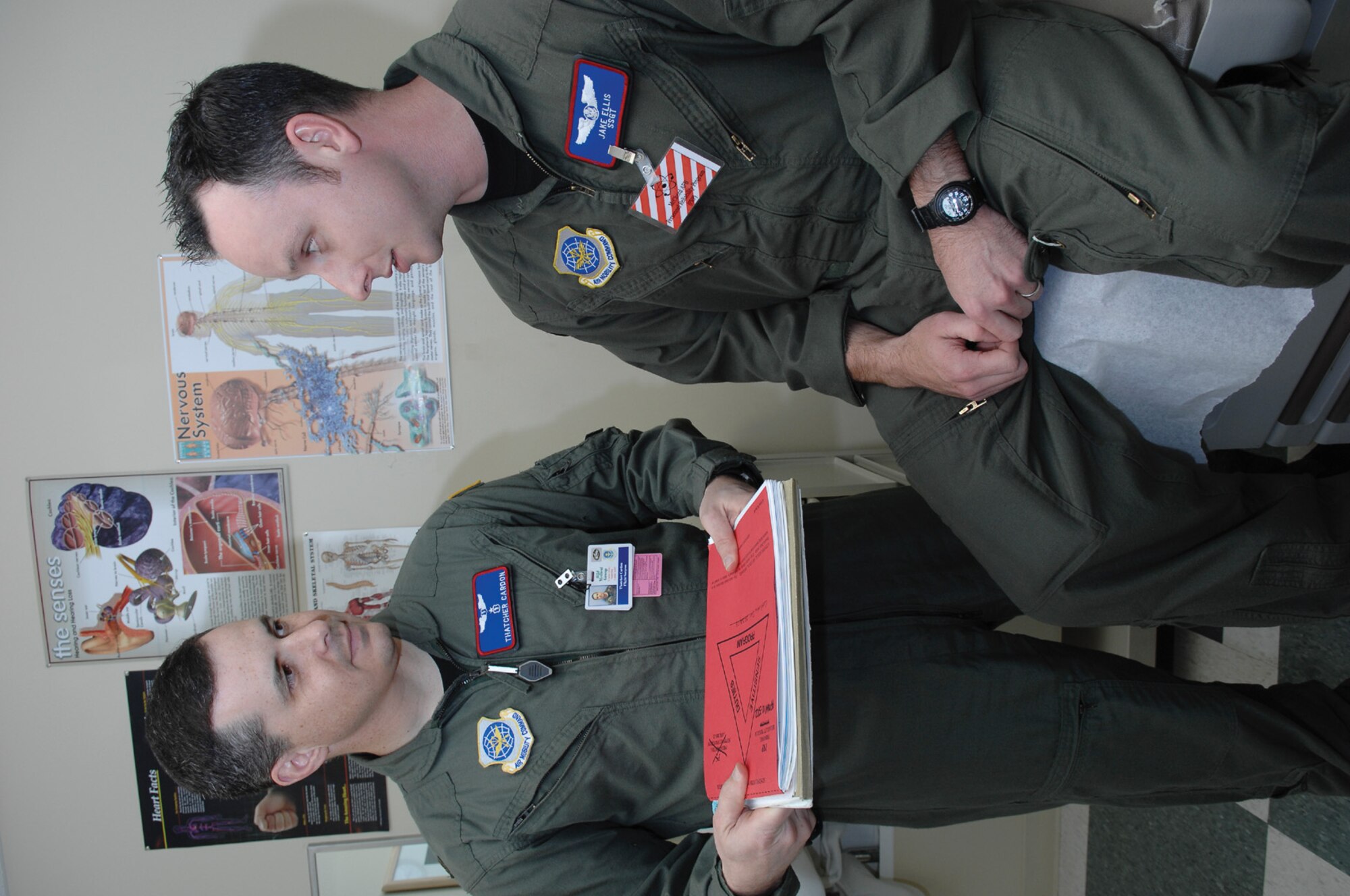 MCCHORD AIR FORCE BASE, Wash.-- Dr. (Maj.) Thatcher Cardon, left, 62nd Medical Operations Squadron flight surgeon, discusses Personnel Reliability Program issues with Staff Sgt. Jake Ellis, 4th Airlift Squadron,  Monday during a visit to flight medicine at the medical building. PRP is a program that that makes sure Airmen responsible for the Prime Nuclear Airlift mission are physically capable, reliable and competent. (U.S. Air Force Photo by Abner Guzman)
