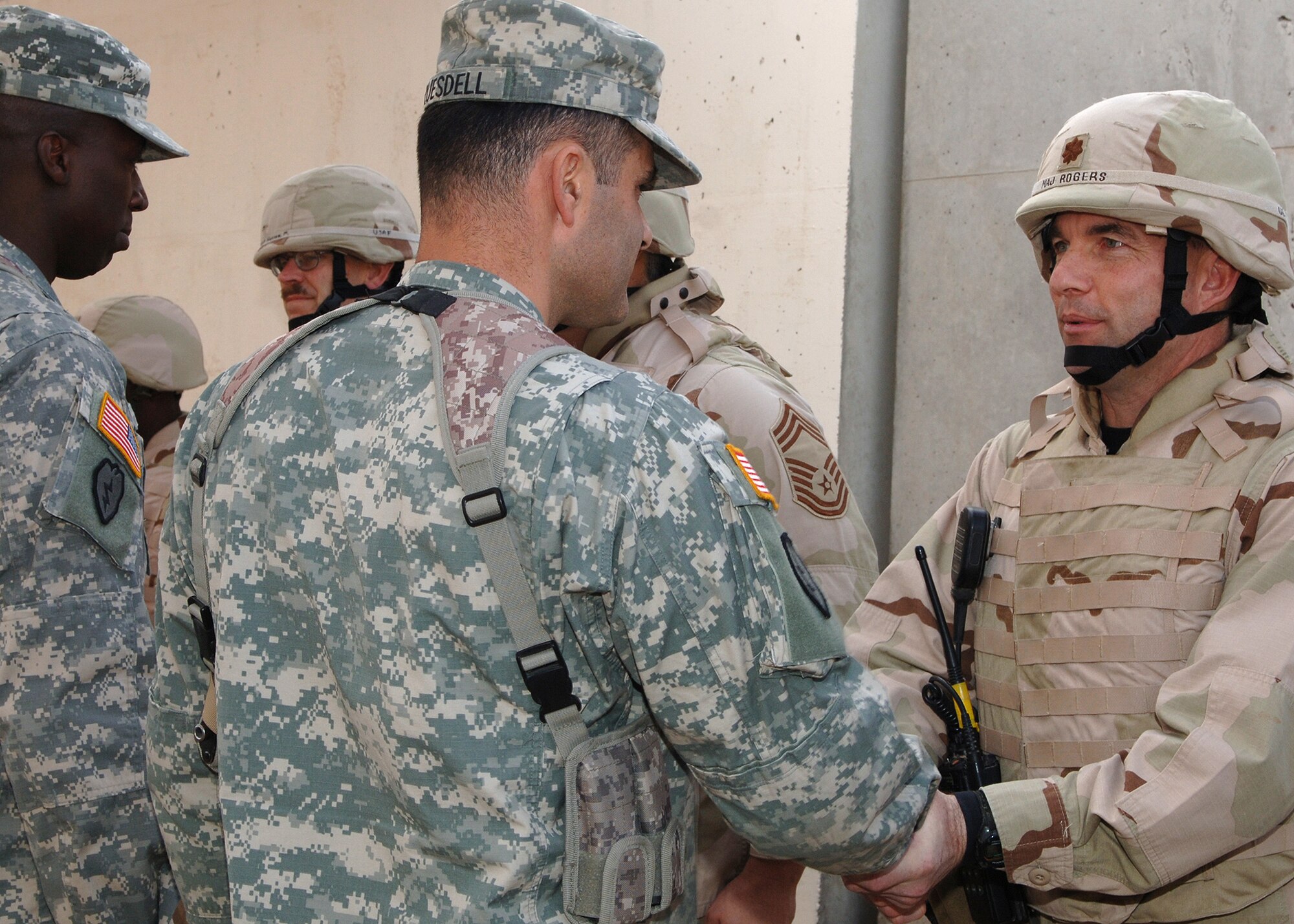 U.S. Army Lt. Col. Bryan Truesdell, center, 3rd Brigade Special Troops Battalion commander, and Command Sergeant Major David Clark, left, award Maj. Mark Rogers and members of the 506th Expeditionary Communications Squadron Information Systems Flight special recognition coins before the flight's return home from Iraq in January. Army leaders at Kirkuk Regional Air Base recognized the deployed Air Force Recruiting Service communications configuration management chief and his 30-Airman shop for providing outstanding telephone and computer network communications for about 5,400 Soldiers, Airmen and Department of Defense employees at Kirkuk RAB from September 2006 to January 2007. The major attributes his flight's success to their diligent practice of maintaining open lines of positive communication between Airmen and Soldiers throughout their deployment. (Courtesy photo)