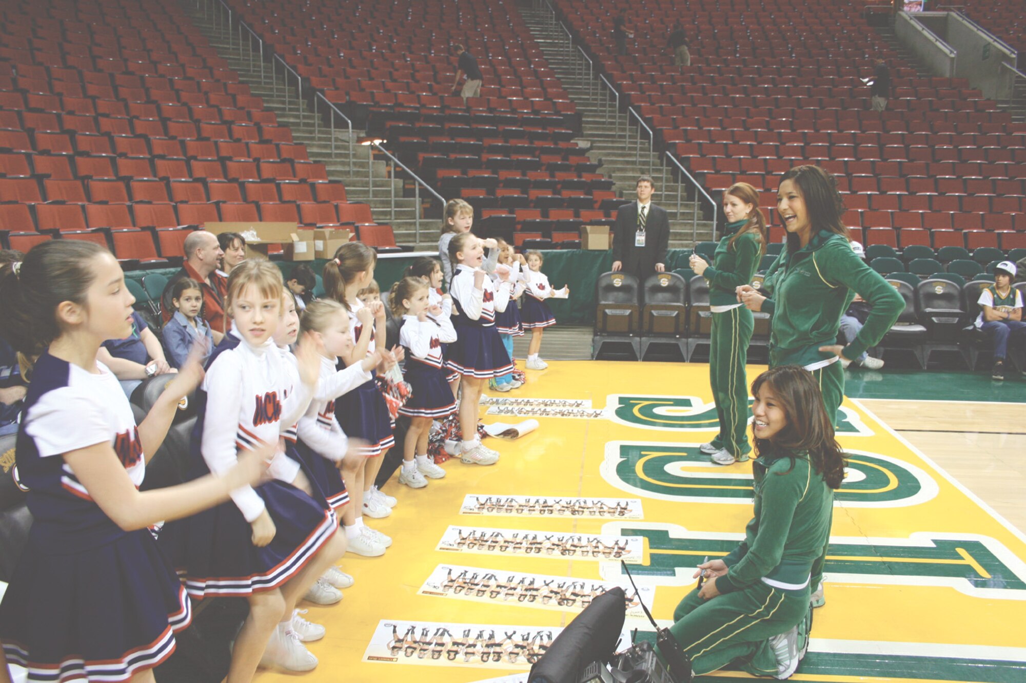 SEATTLE -- Cheerleaders from McChord's youth center show off their skills to some of the Seattle Sonics' cheerleaders before a game on Sunday at Seattle's Key Arena. (Photo by Eddie Jacks)
