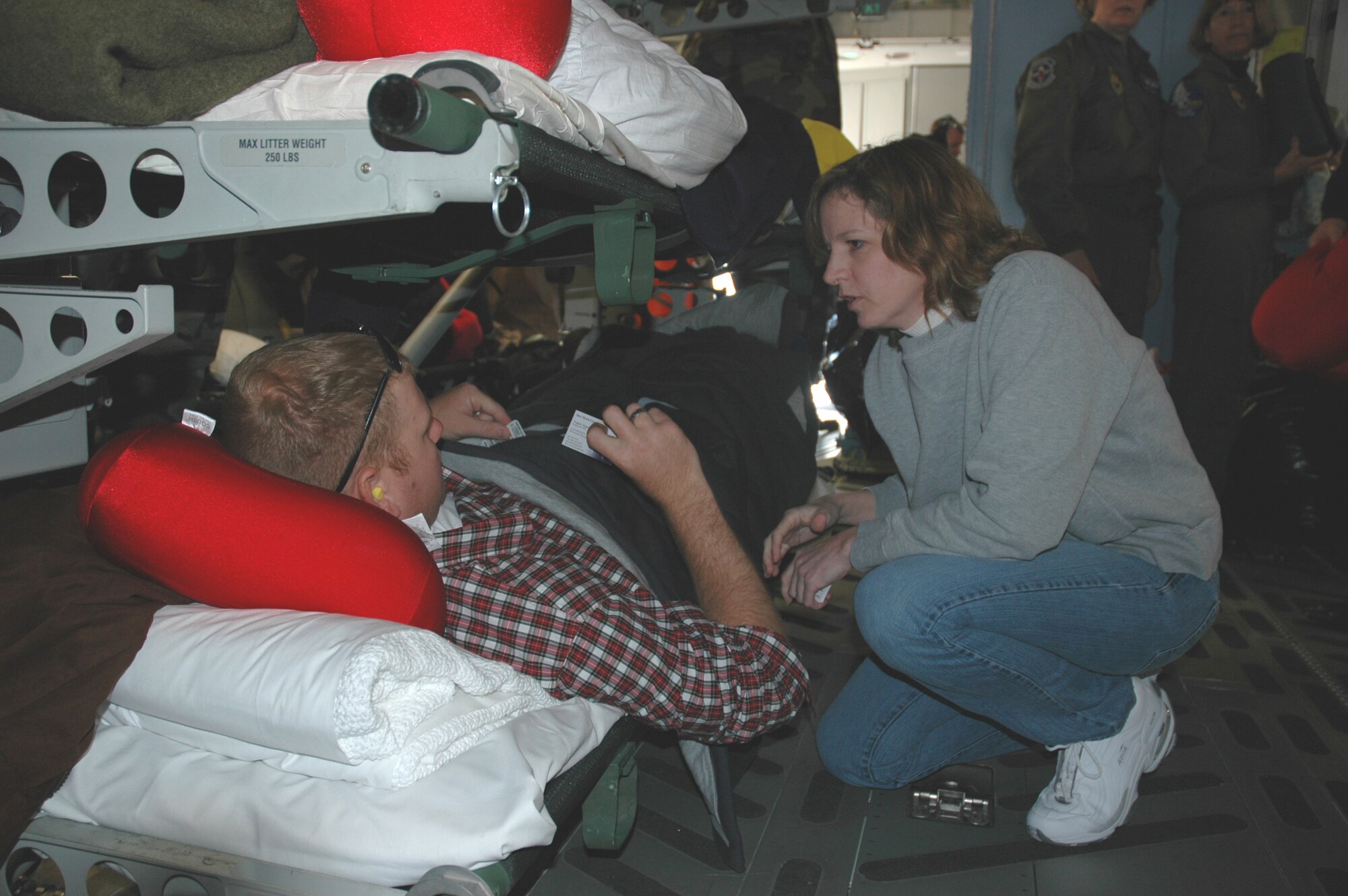 Ginger Dosedel, founder of "Sew Much Comfort", visits with arriving patients from an aeromedical evacuation mission at Ramstein Air Base April 6.  Sew Much Comfort is an all-volunteer nonprofit organization that designs adaptive clothing for wounded and injured servicemembers.  
