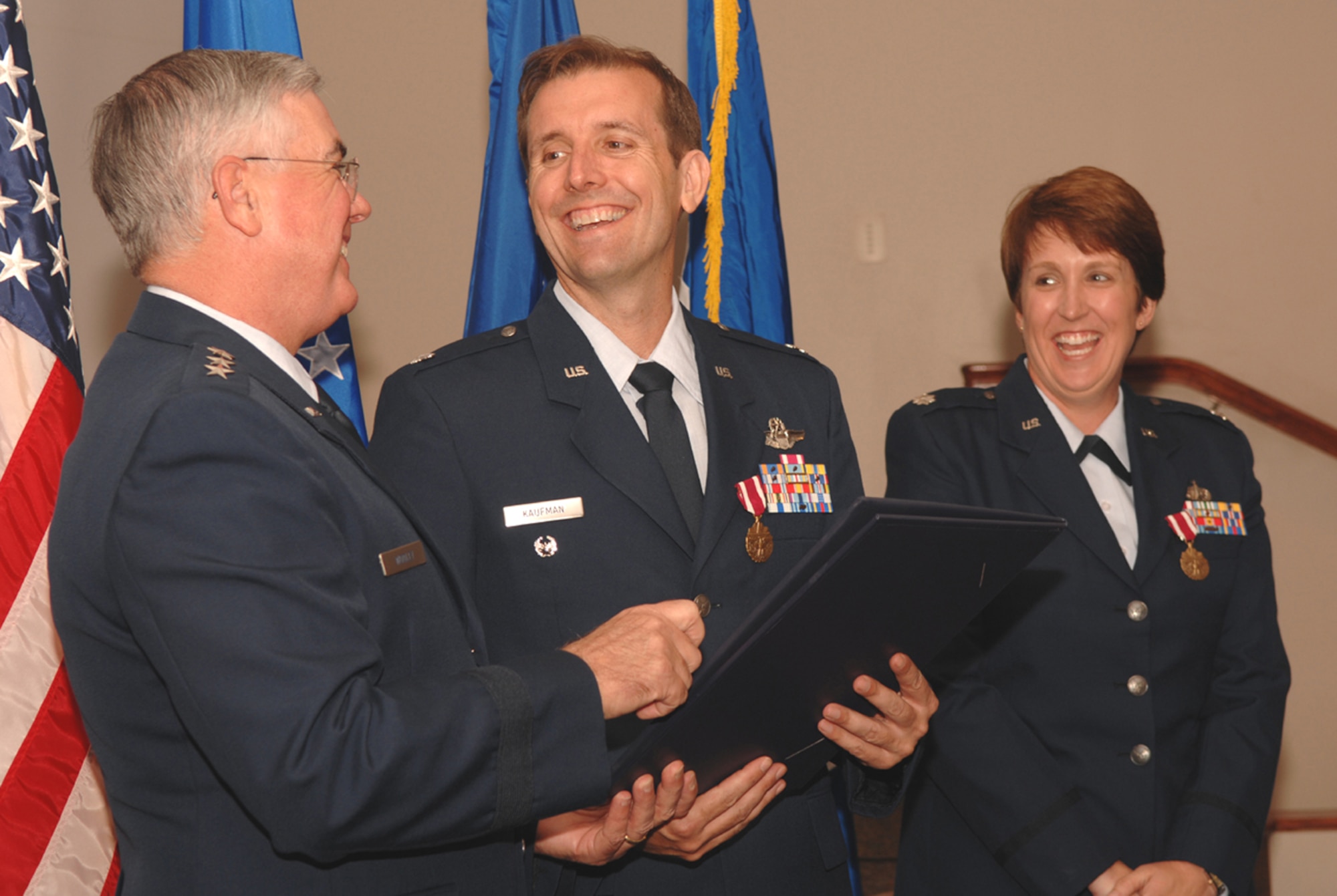 Lt. Gen. Michael Wooley, Air Force Special Operations Command commander, shares a laugh with Lt. Cols. Chris and Pam Kaufman during their dual retirement ceremony March 30. (U.S. Air Force photo by Staff Sgt. Angela Shepherd)