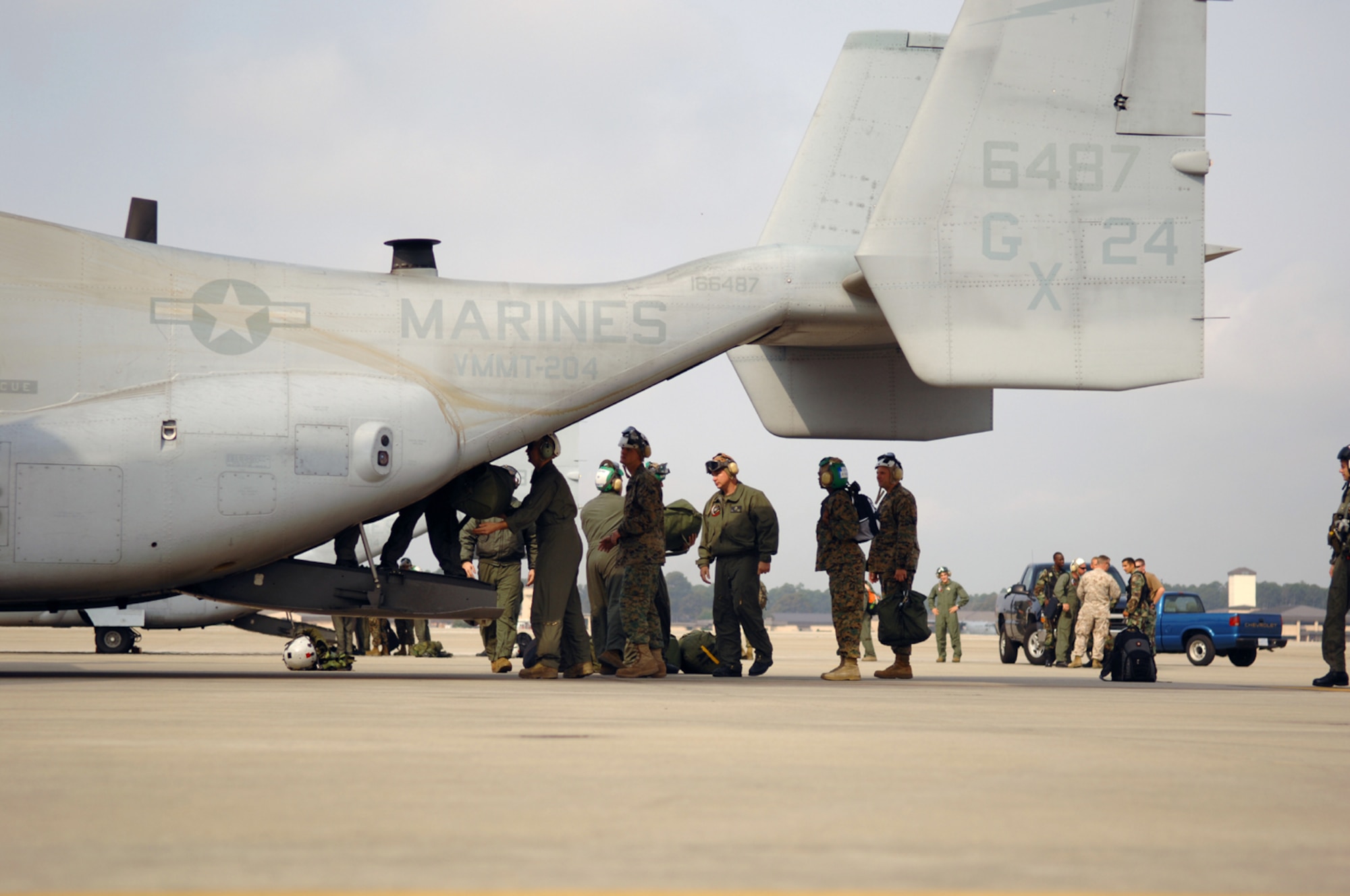 A group of Marines from Marine Corps Air Station New River, N.C., unload their gear after arriving at Hurlburt Field March 27 for nearly two weeks of training. (U.S. Air Force photo by Senior Airman Andy Kin)